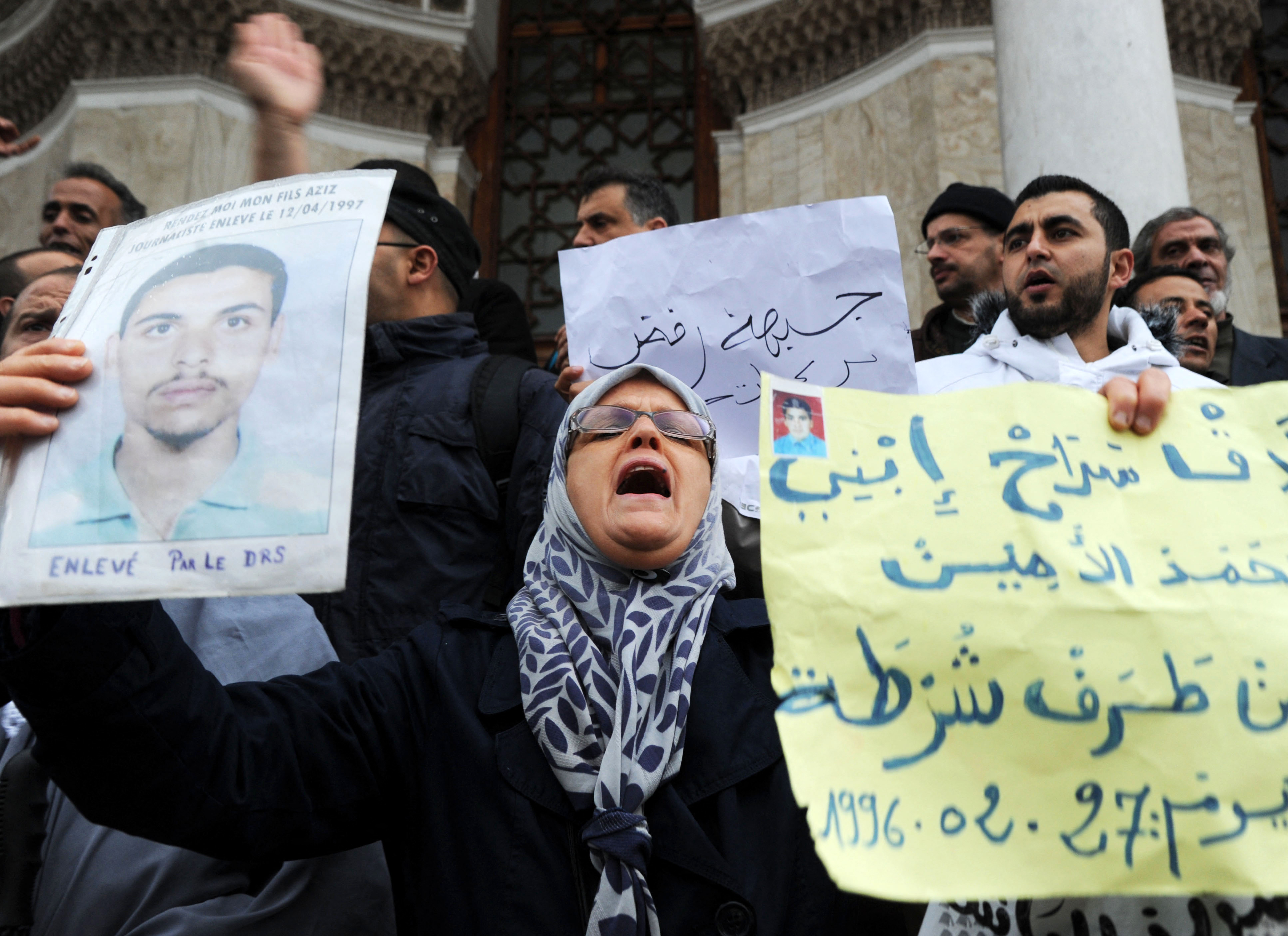 Family members of victims who disappeared during the war in Algeria in the 1990s shout slogans as they take part in a demonstration on March 15, 2014 calling for justice [File: Farouk Batiche/AFP]