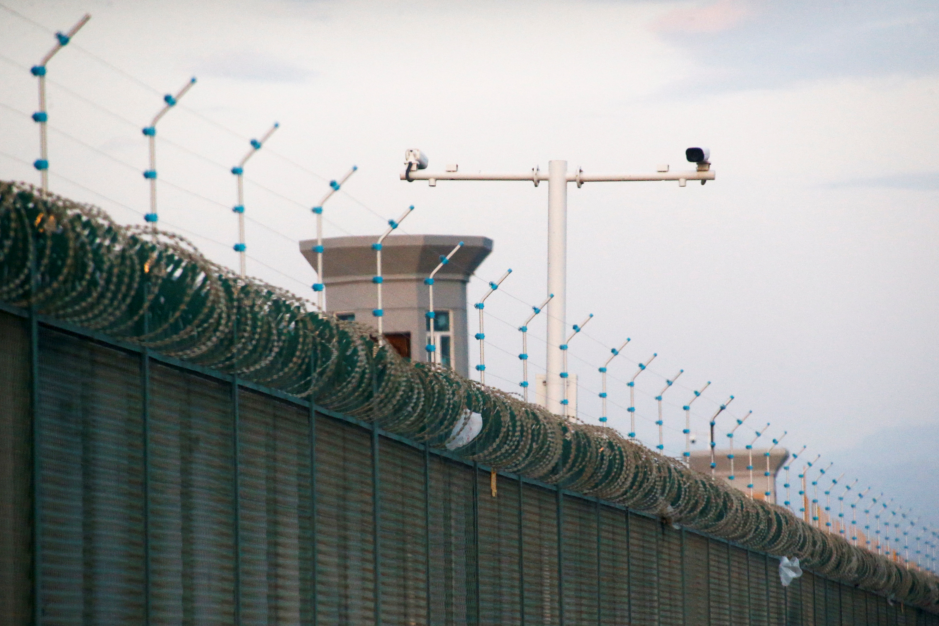 Security cameras are installed above the perimeter fence of what is officially known as a vocational skills education centre in Dabancheng, in Xinjiang Uighur Autonomous Region, China