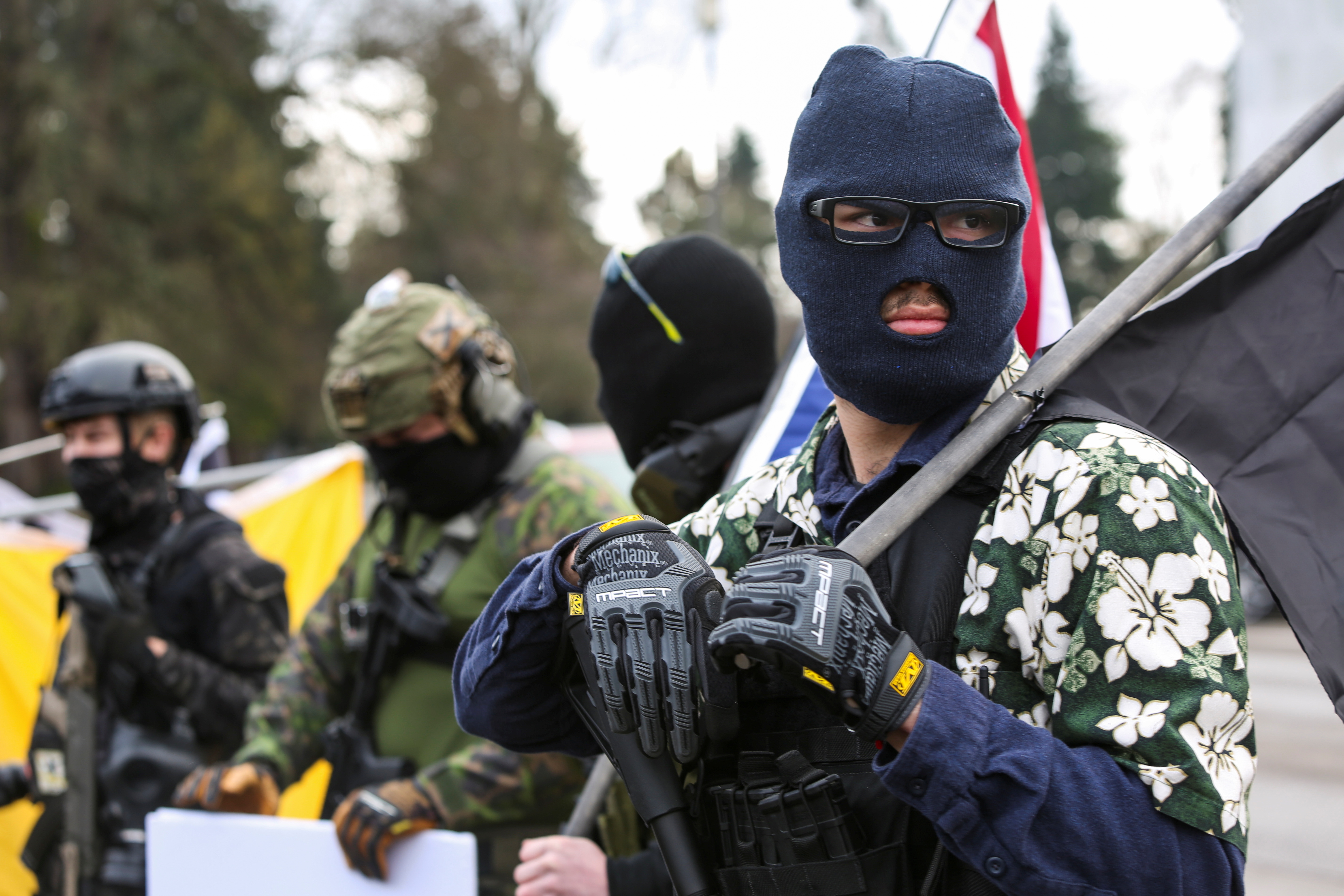 An armed group, who identify as "Liberty Boys" and the anti-government group "Boogaloo Bois" protest outside the Oregon State Capitol, as they advocate for less government control, in Salem, Oregon, U.S., January 17, 2021. REUTERS/Alisha Jucevic