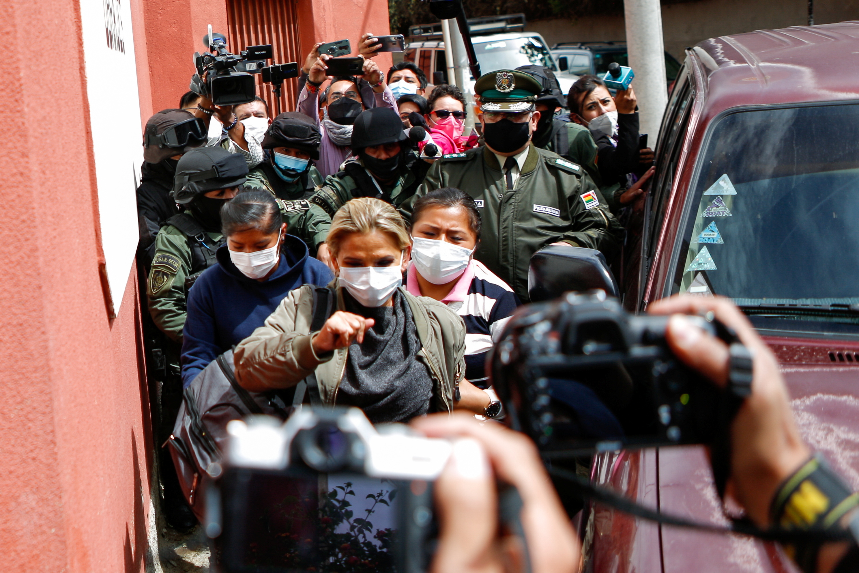 Bolivia's former interim President Jeanine Anez arrives at a women's jail after leaving the FELCC (Special Force to fight against Crime) headquarters, in La Paz, Bolivia, March 15, 2021 [Manuel Claure/Reuters]