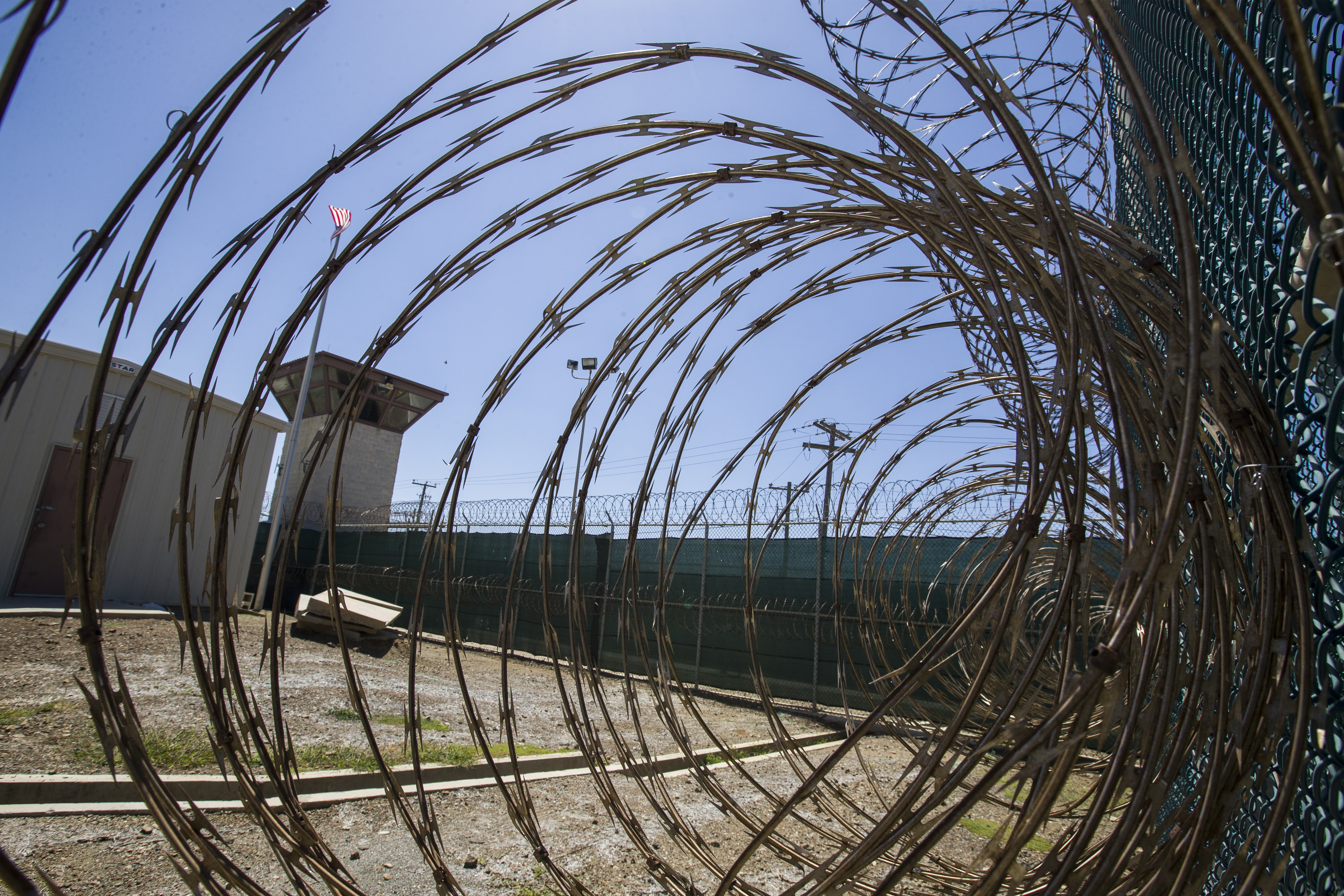 The control tower seen through razor wire inside the Camp VI detention facility in Guantanamo Bay Naval Base, Cuba [File: Alex Brandon/AP Photo]