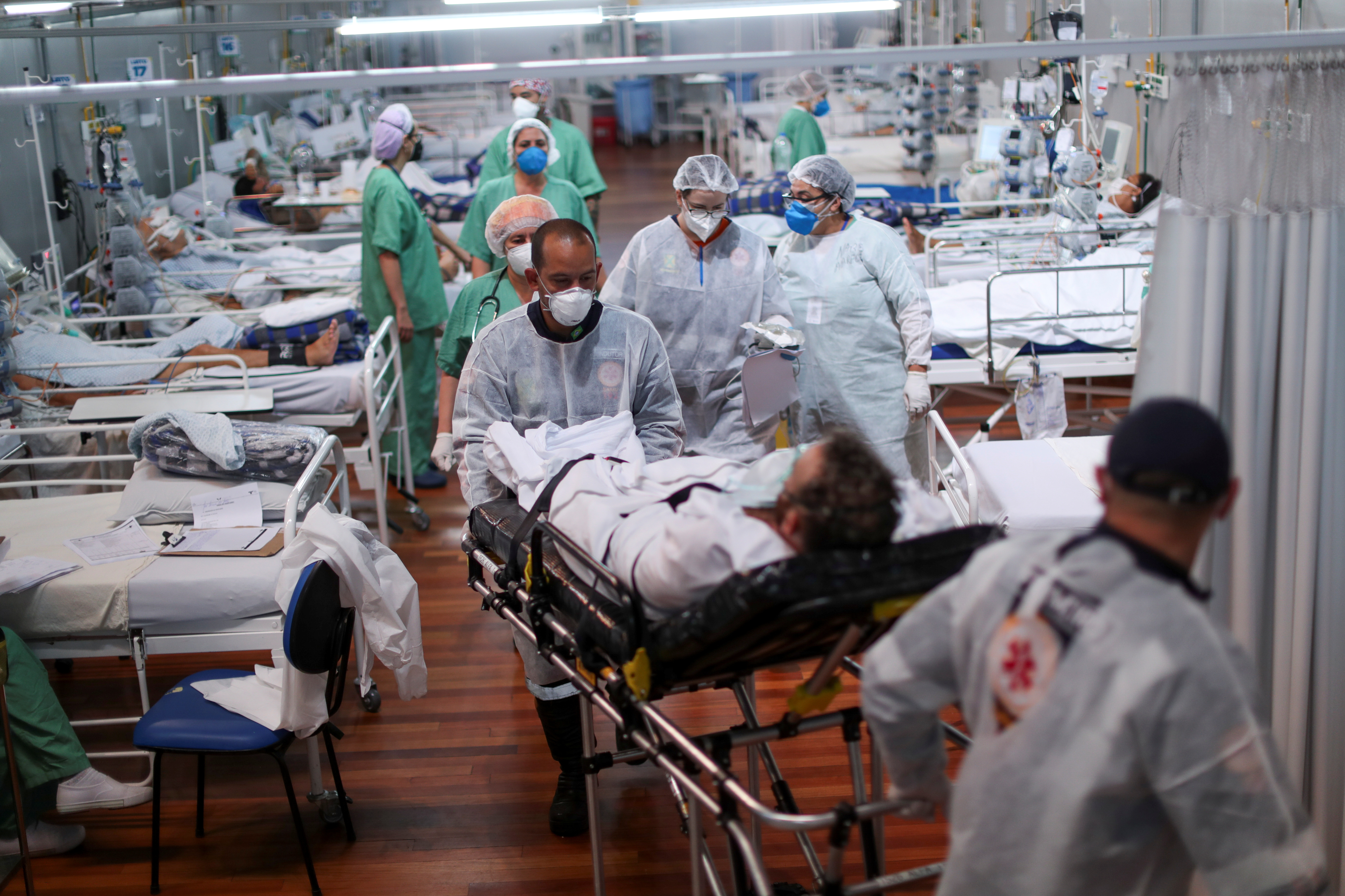 A patient suffering from COVID-19 is transported at a field hospital set up at Dell’Antonia gym in Santo Andre, on the outskirts of Sao Paulo, Brazil
