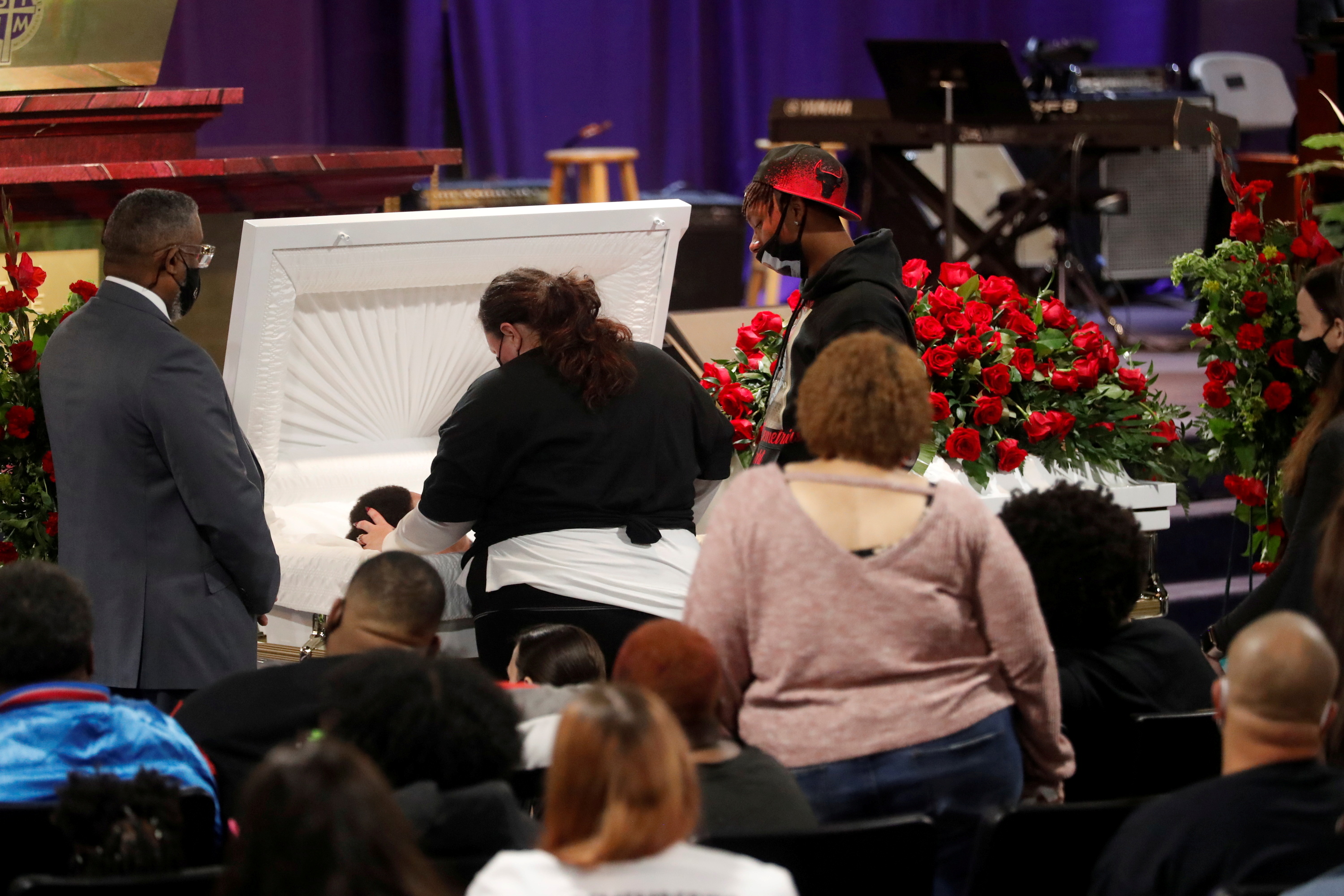 Katie Wright, the mother of Daunte Wright, touches her son in a coffin during a viewing service, after he was shot and killed by Brooklyn Center Police Officer Kim Potter, at his public viewing at Shiloh Temple International Ministries in Minneapolis, Minnesota, US [Octavio Jones/Reuters]