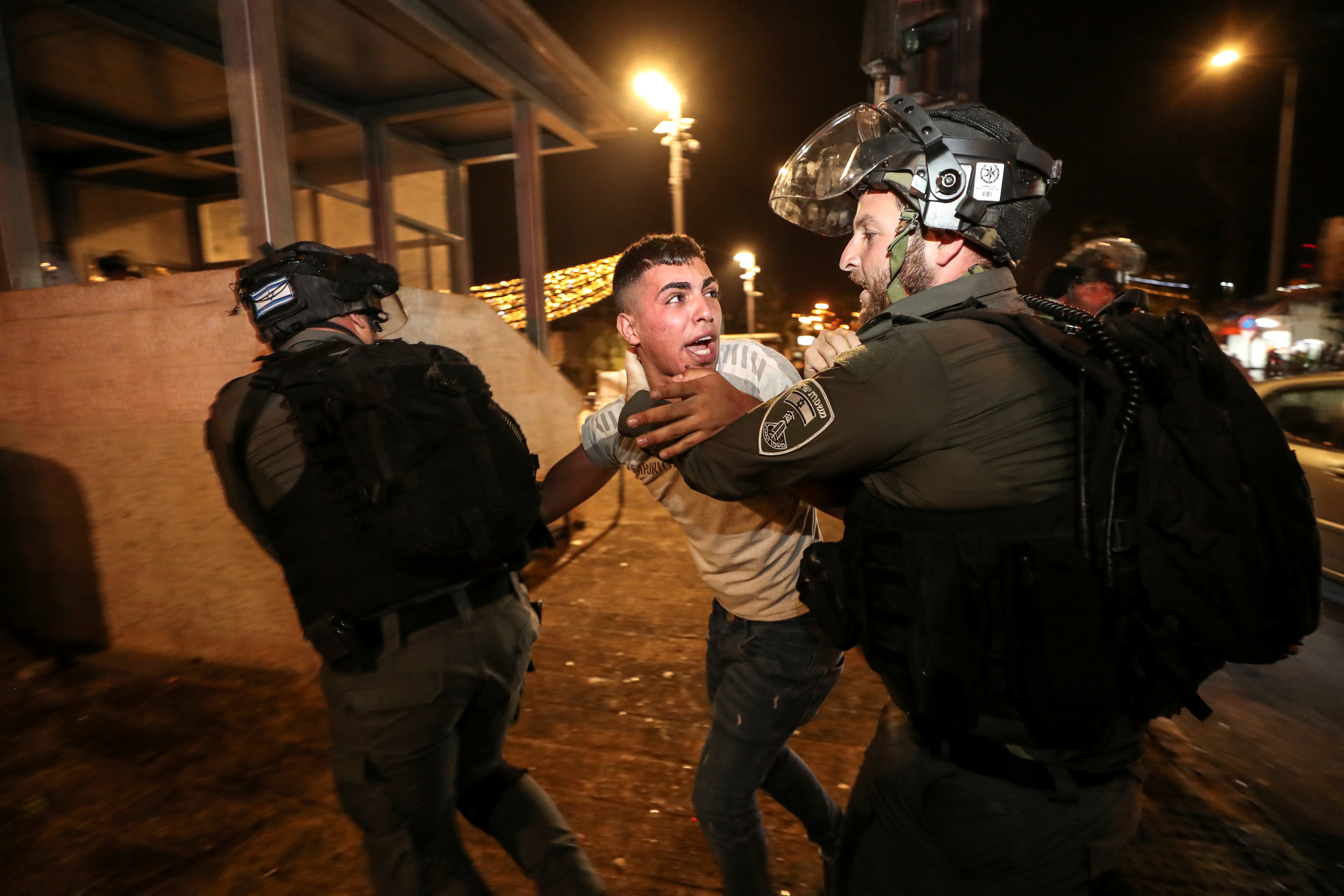 Israeli police detain a Palestinian at Jerusalem’s Old City during protests
