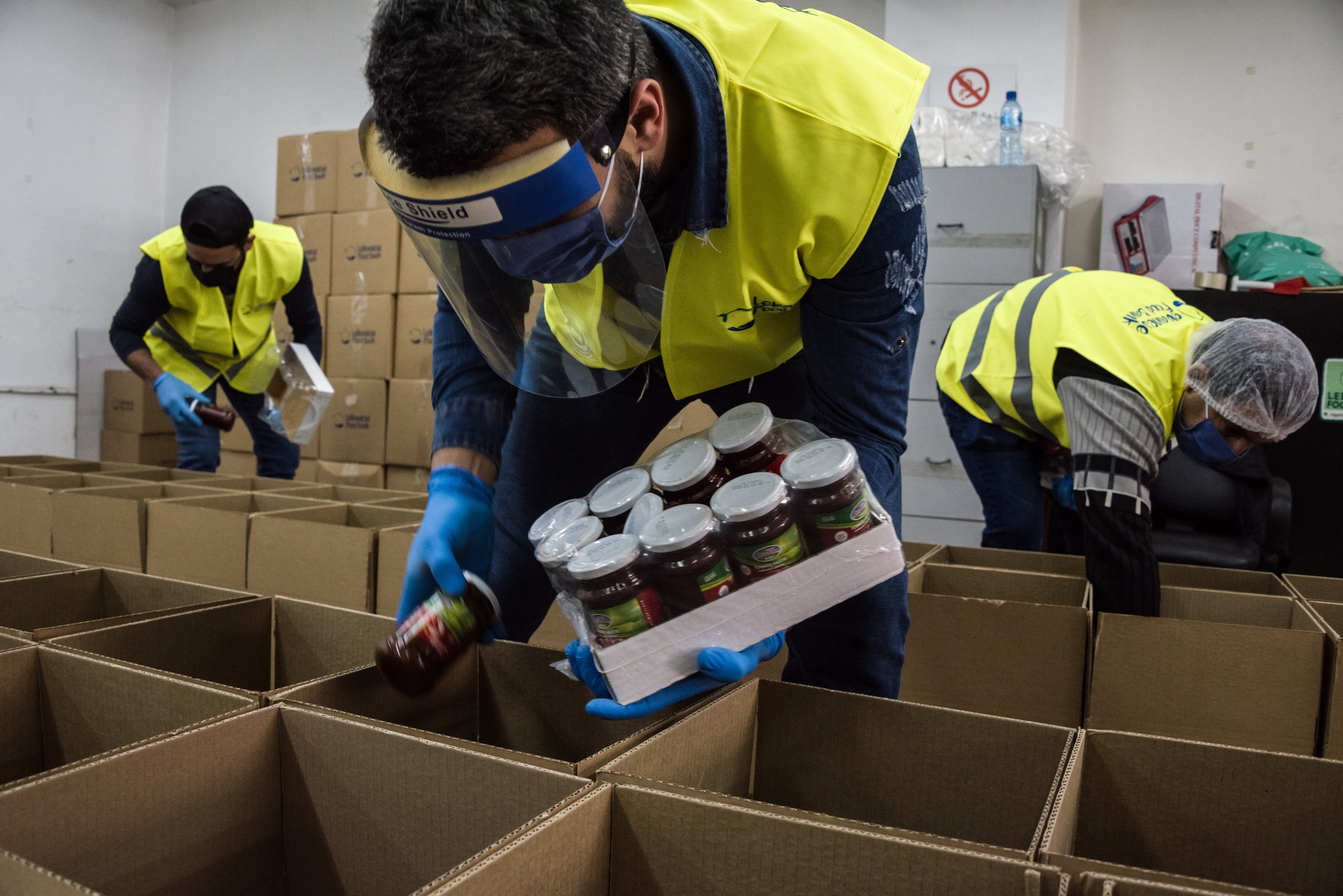 Lebanese Food Bank staff pack boxes distributed to needy families during the struggling country's economic crisis [Courtesy: Lebanese Food Bank]