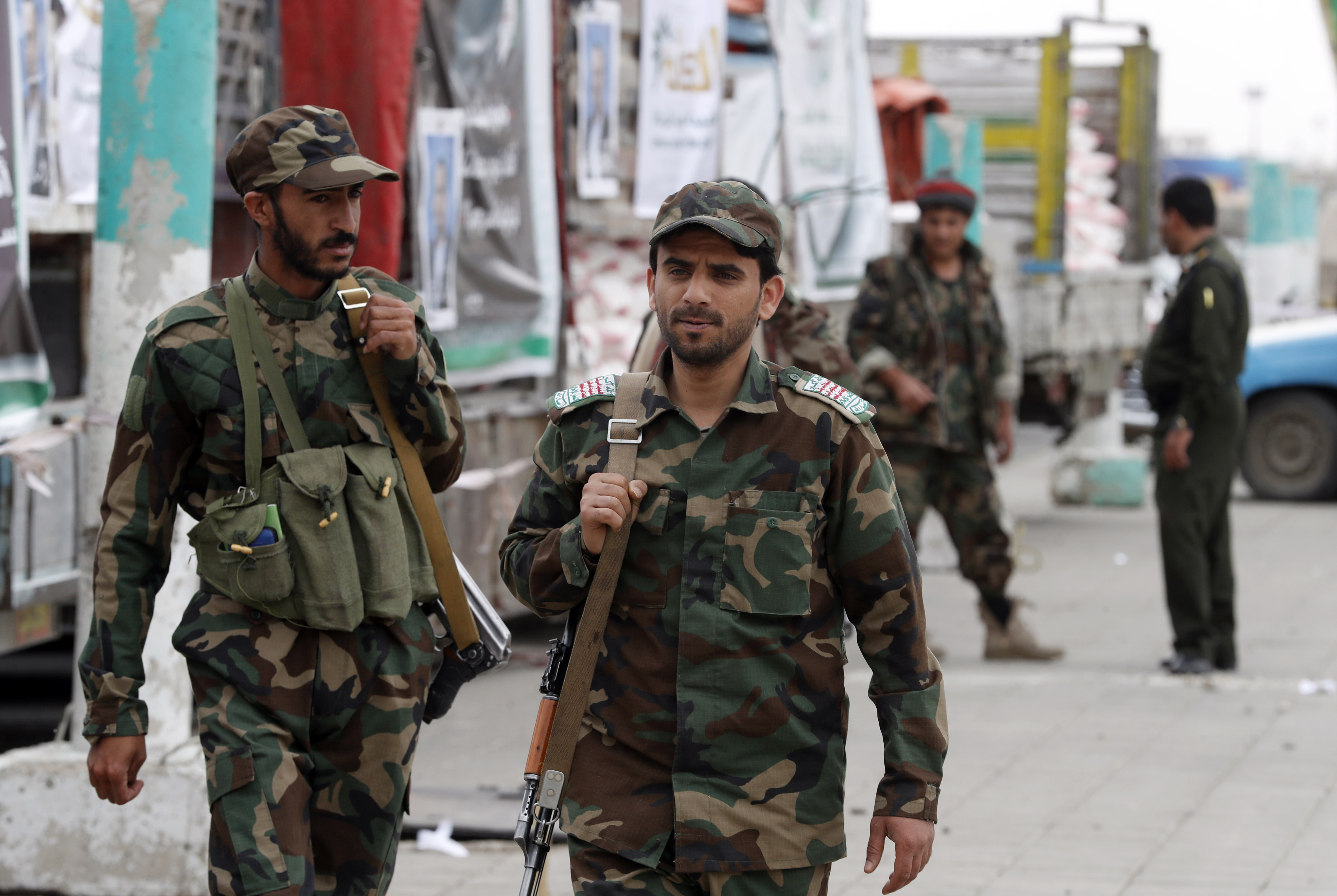 Houthi soldiers patrol a square