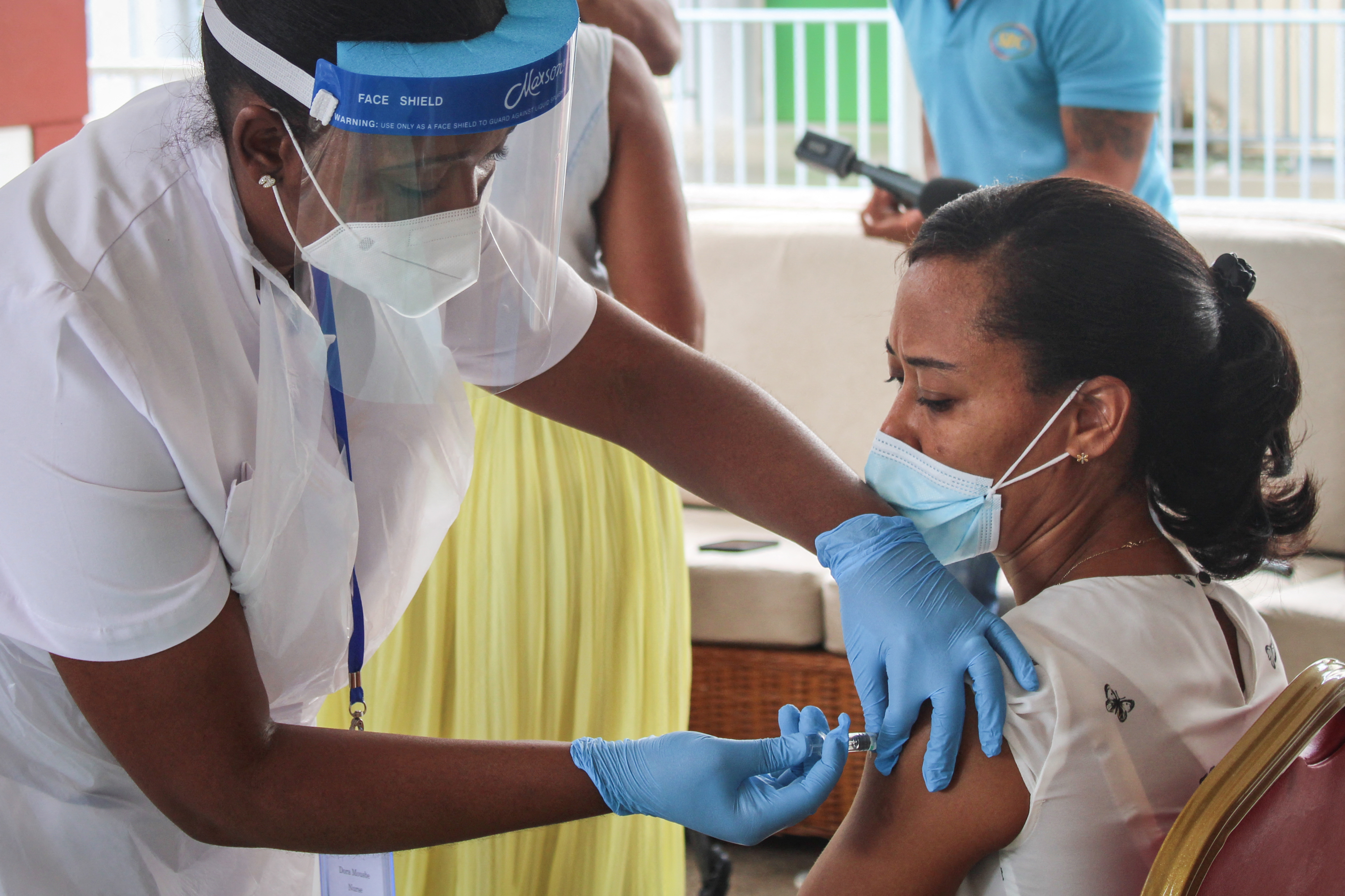 A medic administers a COVID-19 vaccine in the Seychelles. The WHO is reviewing the data after the health ministry found 37 percent of people testing positive for the disease in the last week had received both doses [File: Rassin Vannier/AFP]