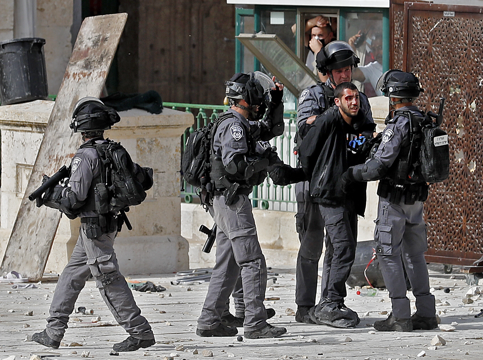 Israeli security forces detain a Palestinian protester at Al-Aqsa Mosque compound on Monday