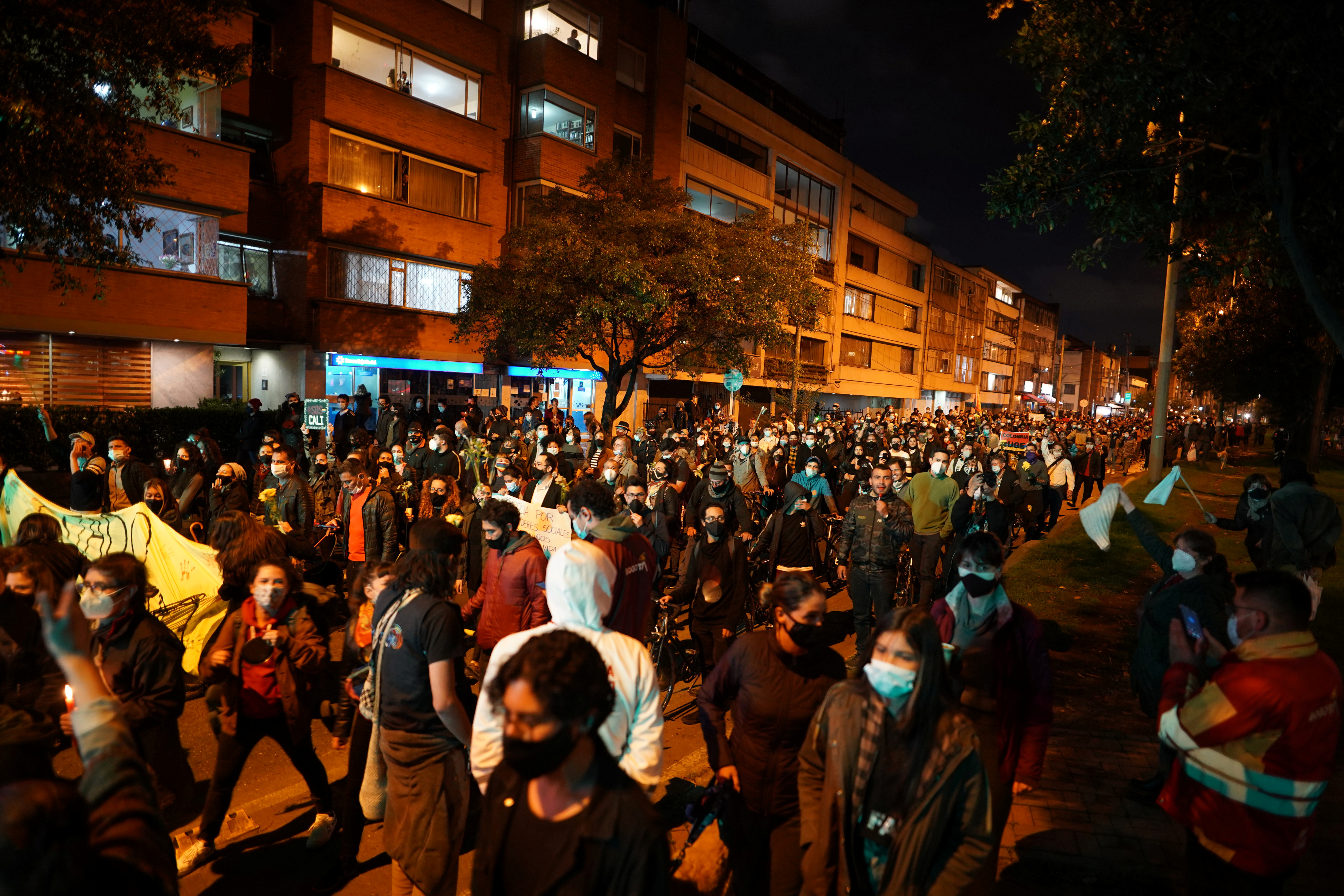 Demonstrators take part in a protest demanding government action to tackle poverty, police violence and inequalities in the health and education systems, in Bogota on Thursday