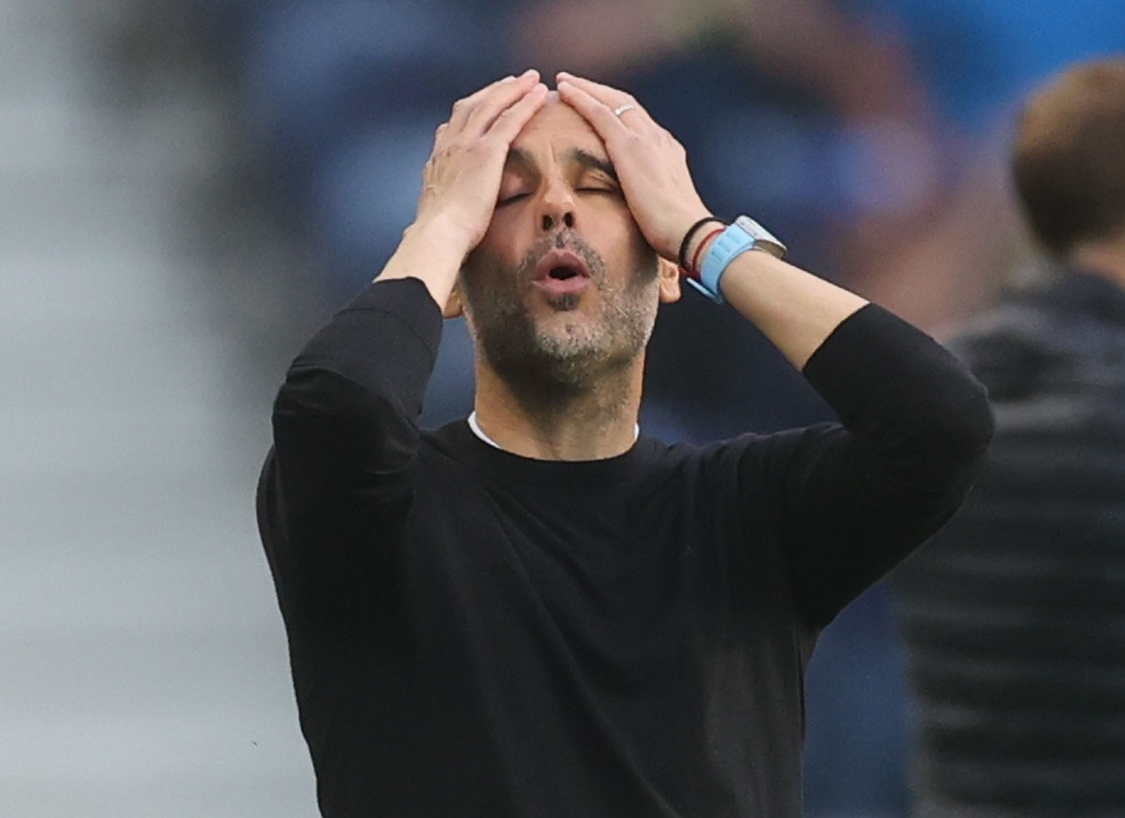 Manchester City coach Pep Guardiola raises his hands to his face