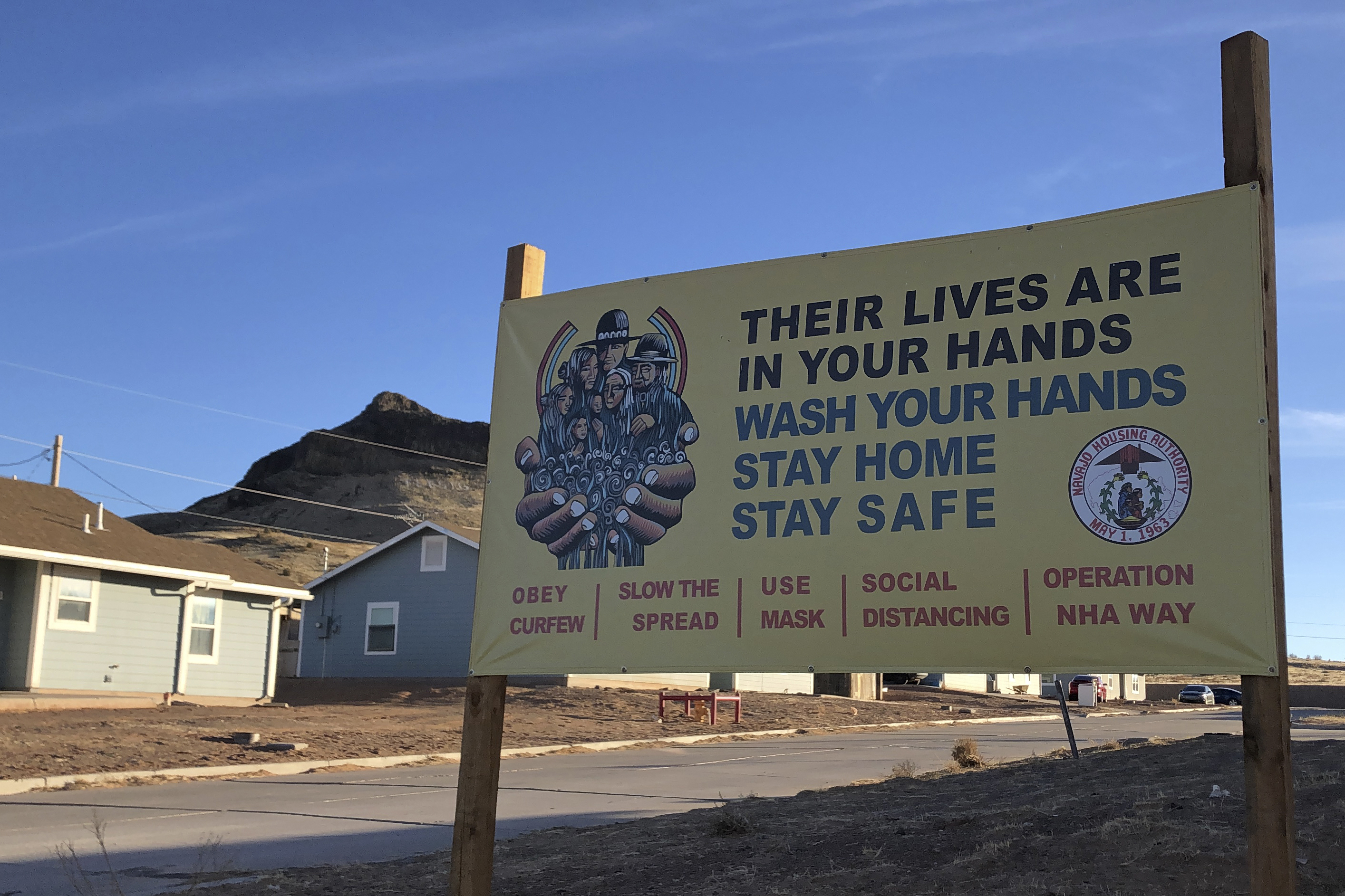 A sign urging safety measures during the coronavirus pandemic is seen on the Navajo Nation on February 11, 2021 [File: Felicia Fonseca/AP Photo]
