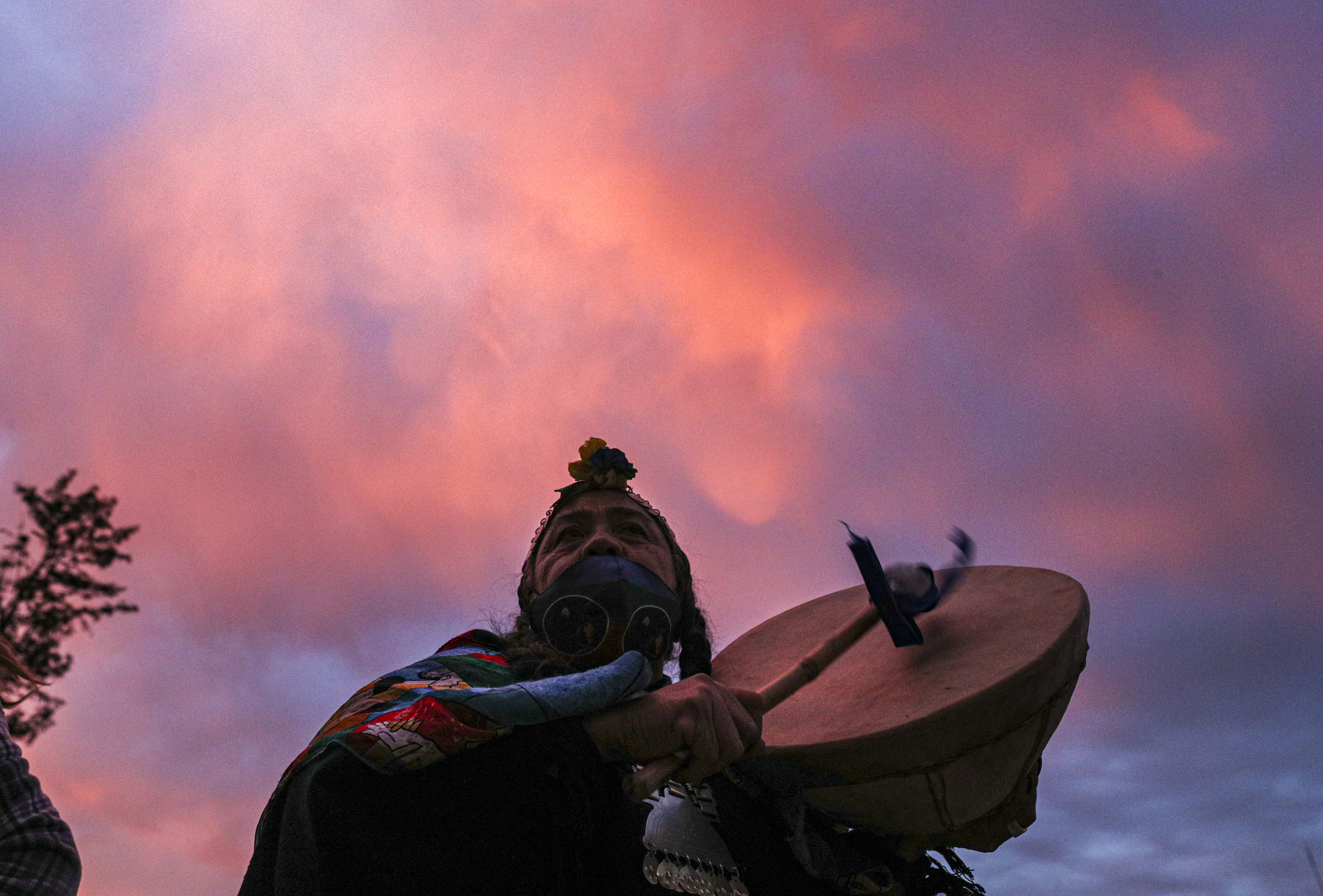 Indigenous Mapuche candidate Juana Millal plays a kultrun drum while campaigning in Santiago, Chile. Chileans will vote on May 15 and 16 to elect members who will draft a new constitution [Esteban Felix/AP Photo]