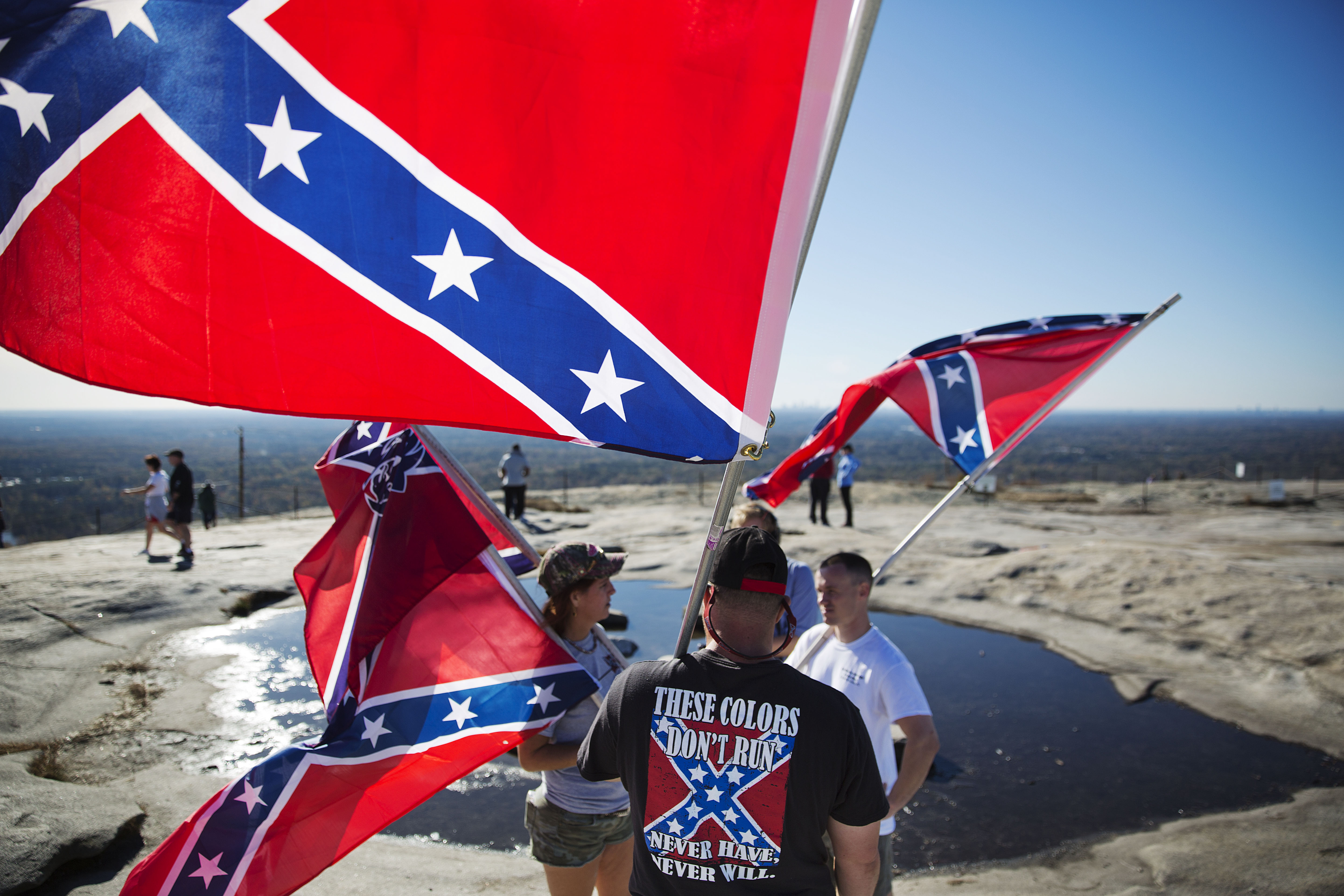 Confederate flag supporters gather at the top of Stone Mountain after hiking up during a 2015 rally [File: David Goldman/AP Photo]
