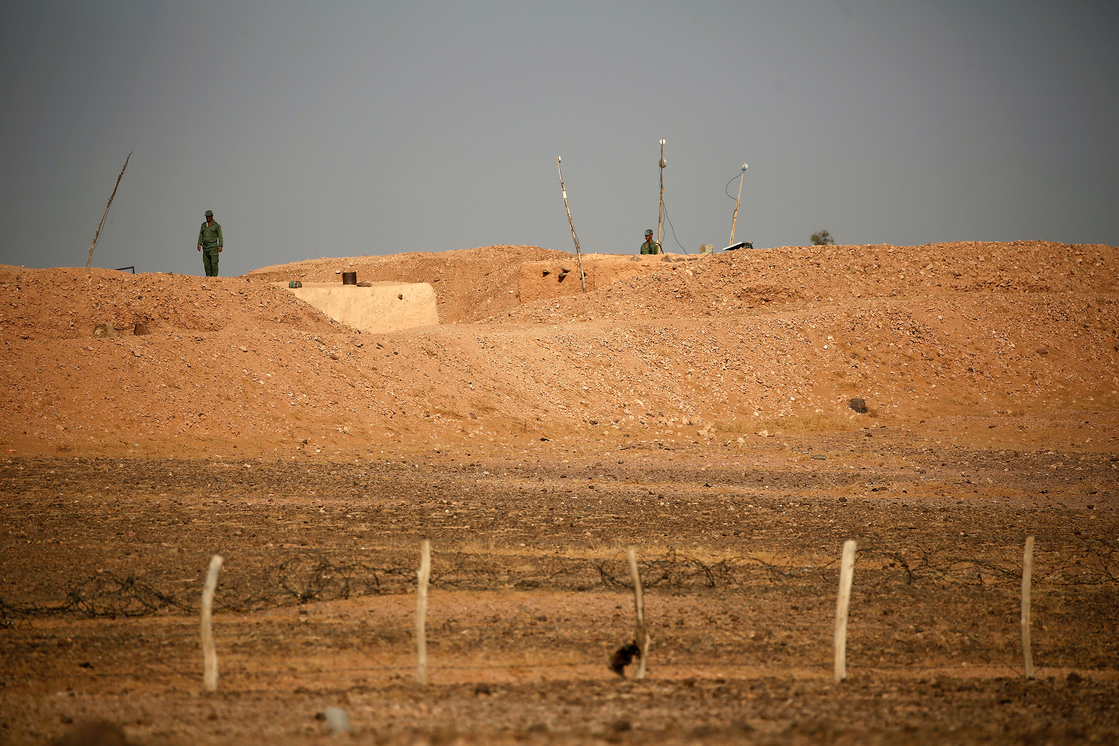 Moroccan soldiers are seen on an earth wall that separates areas controlled by Morocco and the Polisario Front in Western Sahara