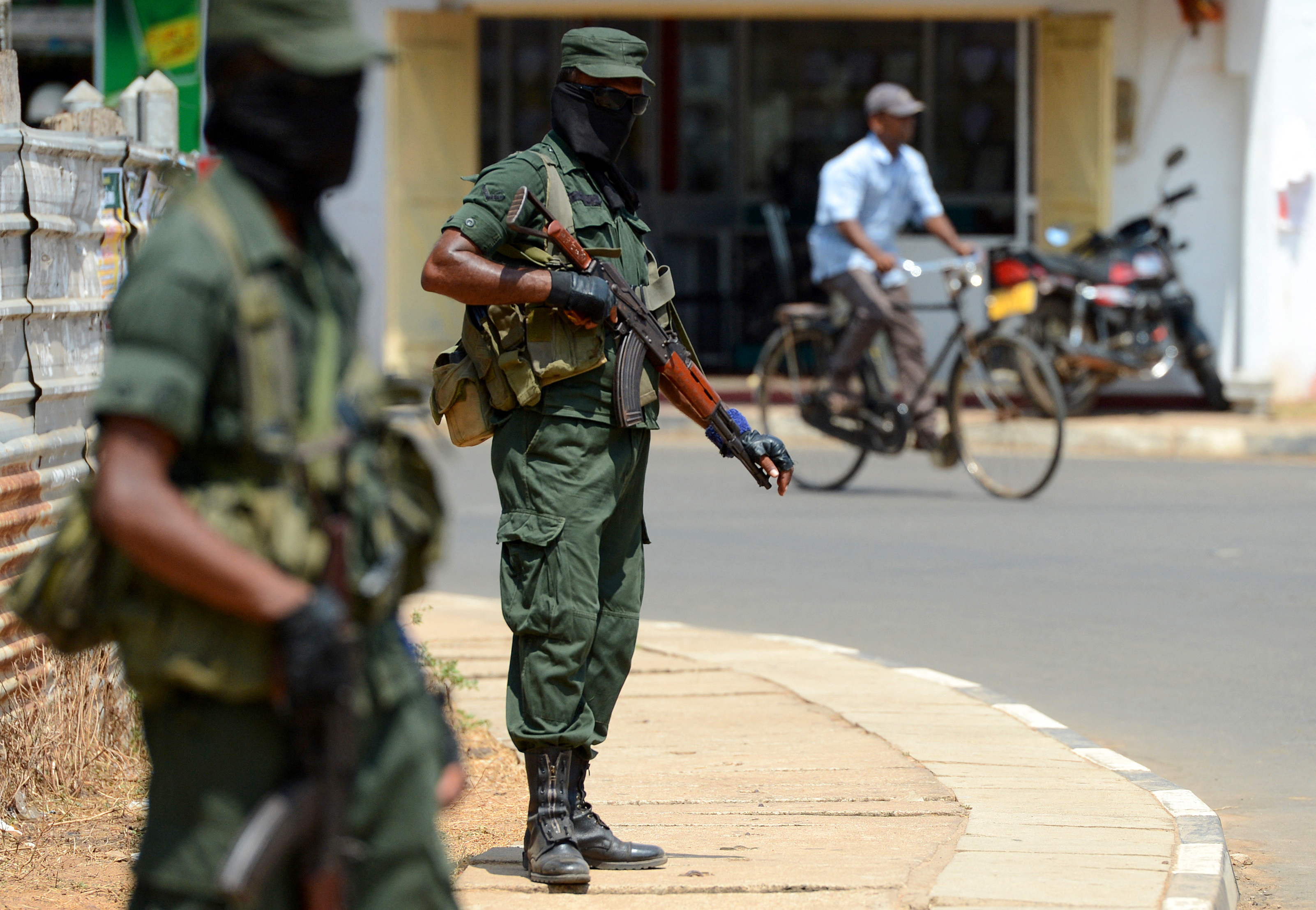 Sri Lankan troopers stand guard in the district of Mullaittivu on May 17, 2018, before the 10th anniversary of Sri Lankan troops defeating Tamil Tiger rebels and declaring an end to a 37-year-old separatist war that killed at least 100,000 people [File: Ishara S Kodikara/AFP]