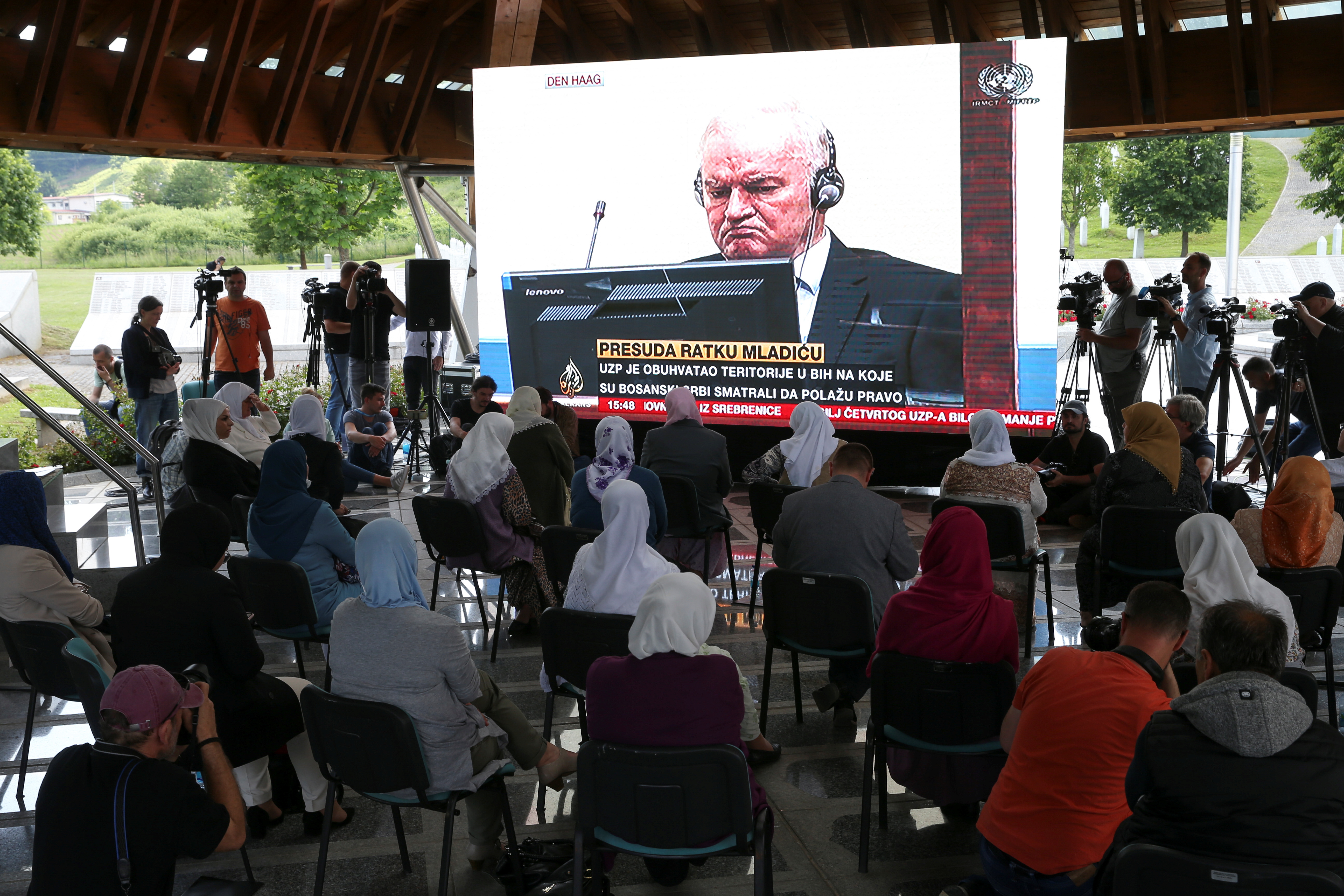 Bosnian Muslim women watch a televised broadcast of the final verdict of former Bosnian Serb military leader Ratko Mladic, in the Srebrenica-Potocari Genocide Memorial Center, Bosnia and Herzegovina on June 8, 202 [Dado Ruvić/Reuters]