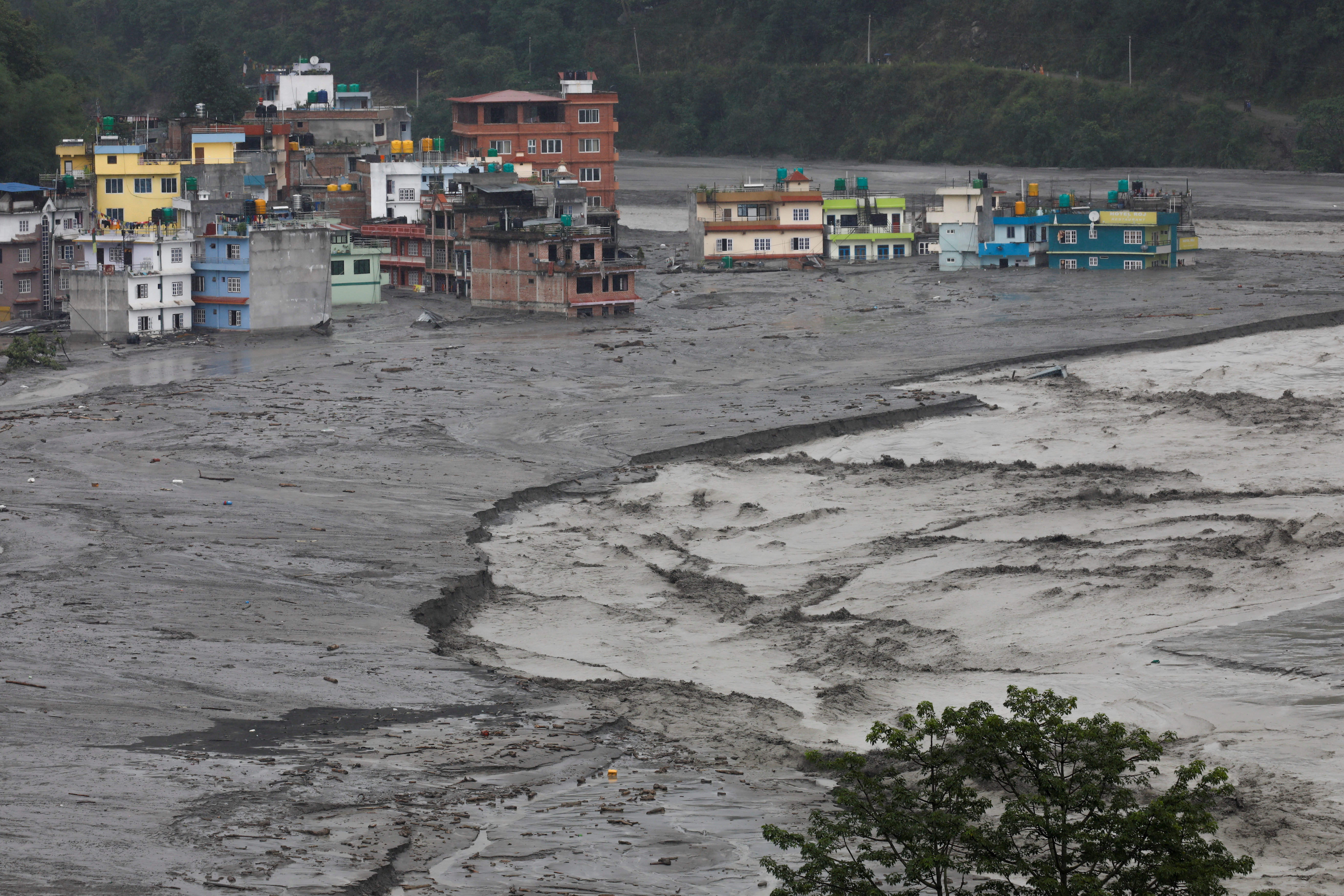 A general view shows houses hit by flash floods along the bank of the Melamchi river in Sindhupalchowk, Nepal [Navesh Chitrakar/Reuters]