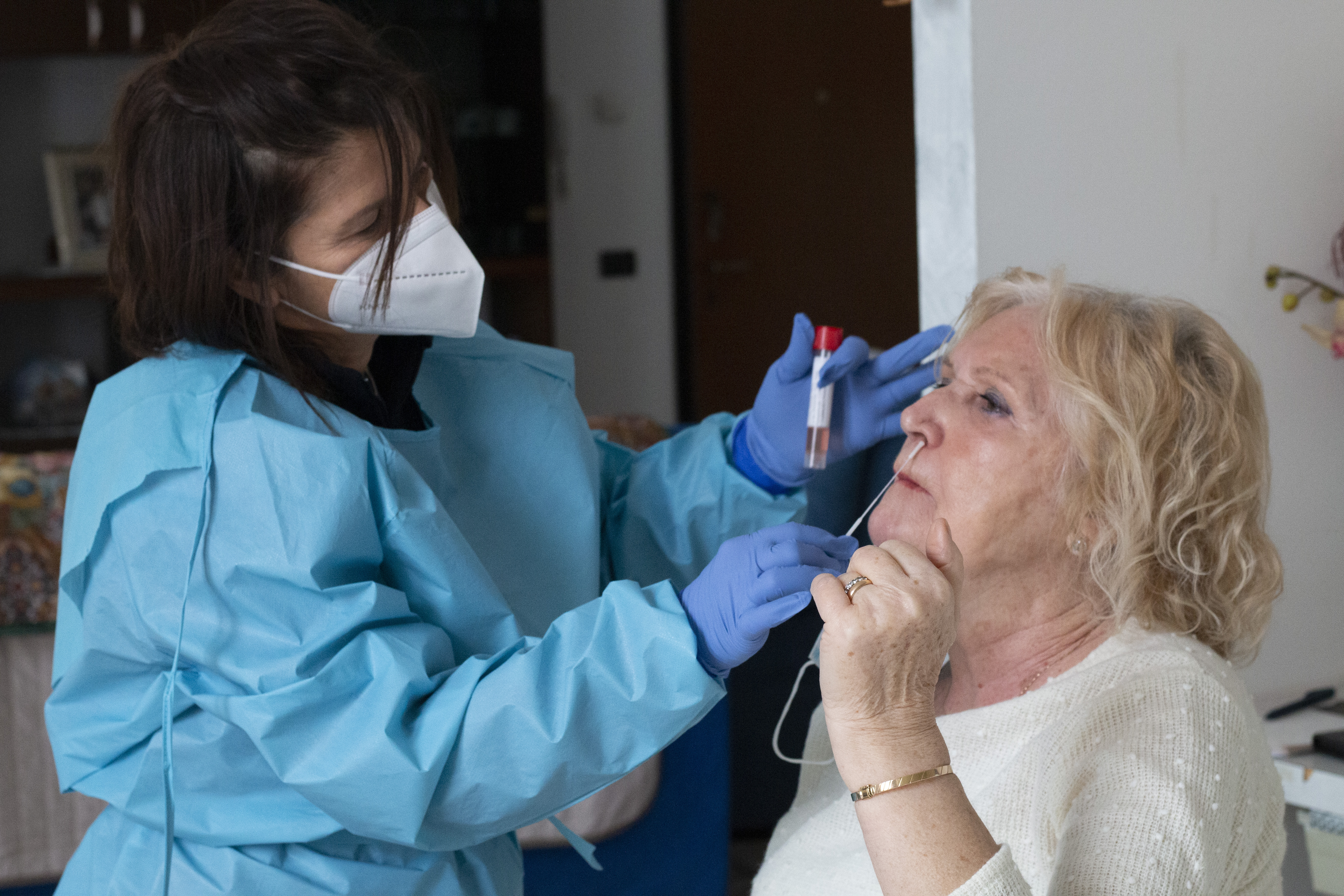 A senior citize is getting vaccinated in Italy