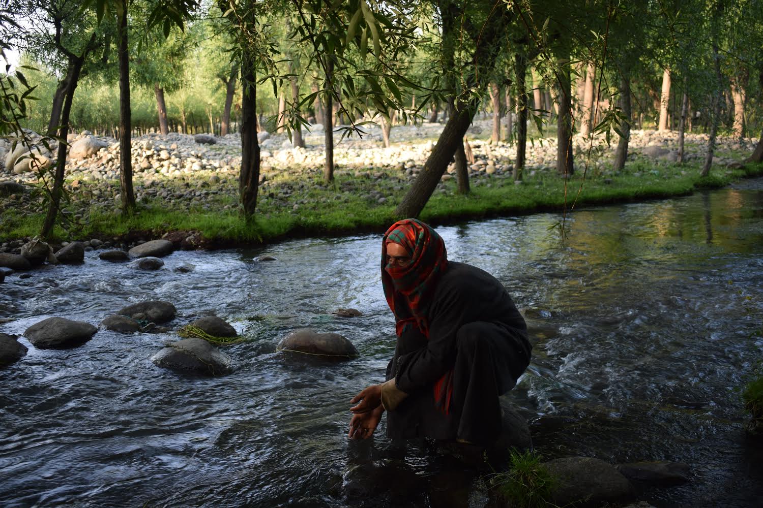 Muskaan from the region's Kulgam district washing her hands after a long day of mining the riverbed [Zubair Amin/Al Jazeera]