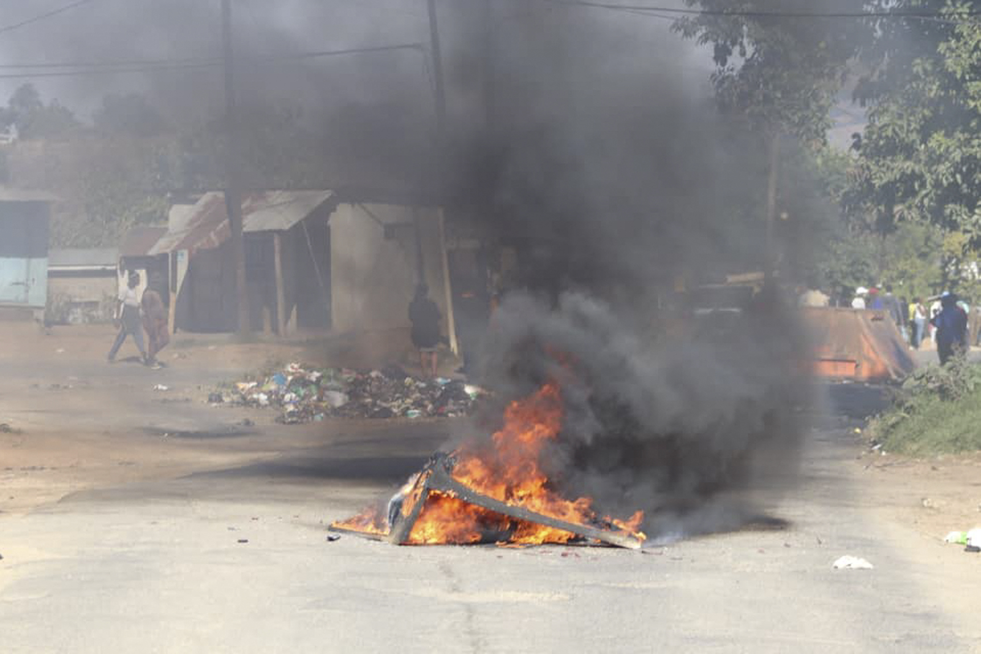 A barricade in the road that is on fire is seen in Mbabane, Eswatini, on June 29, 2021