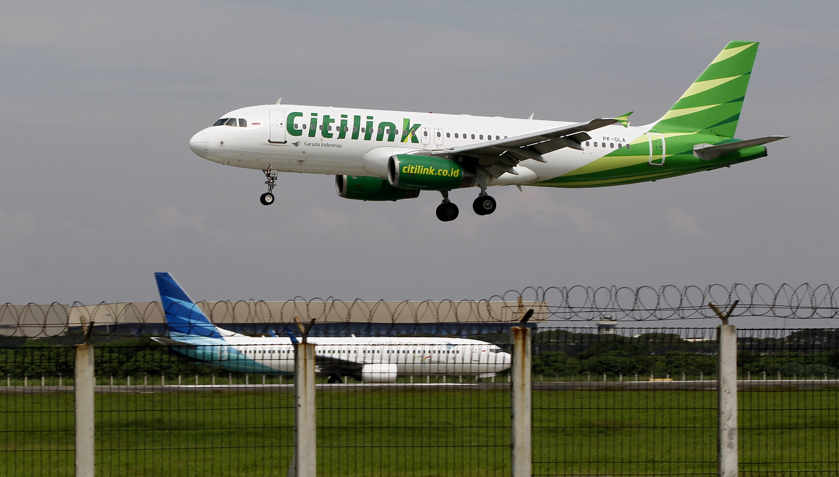 A Citilink Airbus A320 approaches for a landing at Soekarno–Hatta International Airport in Jakarta June 14, 2013.