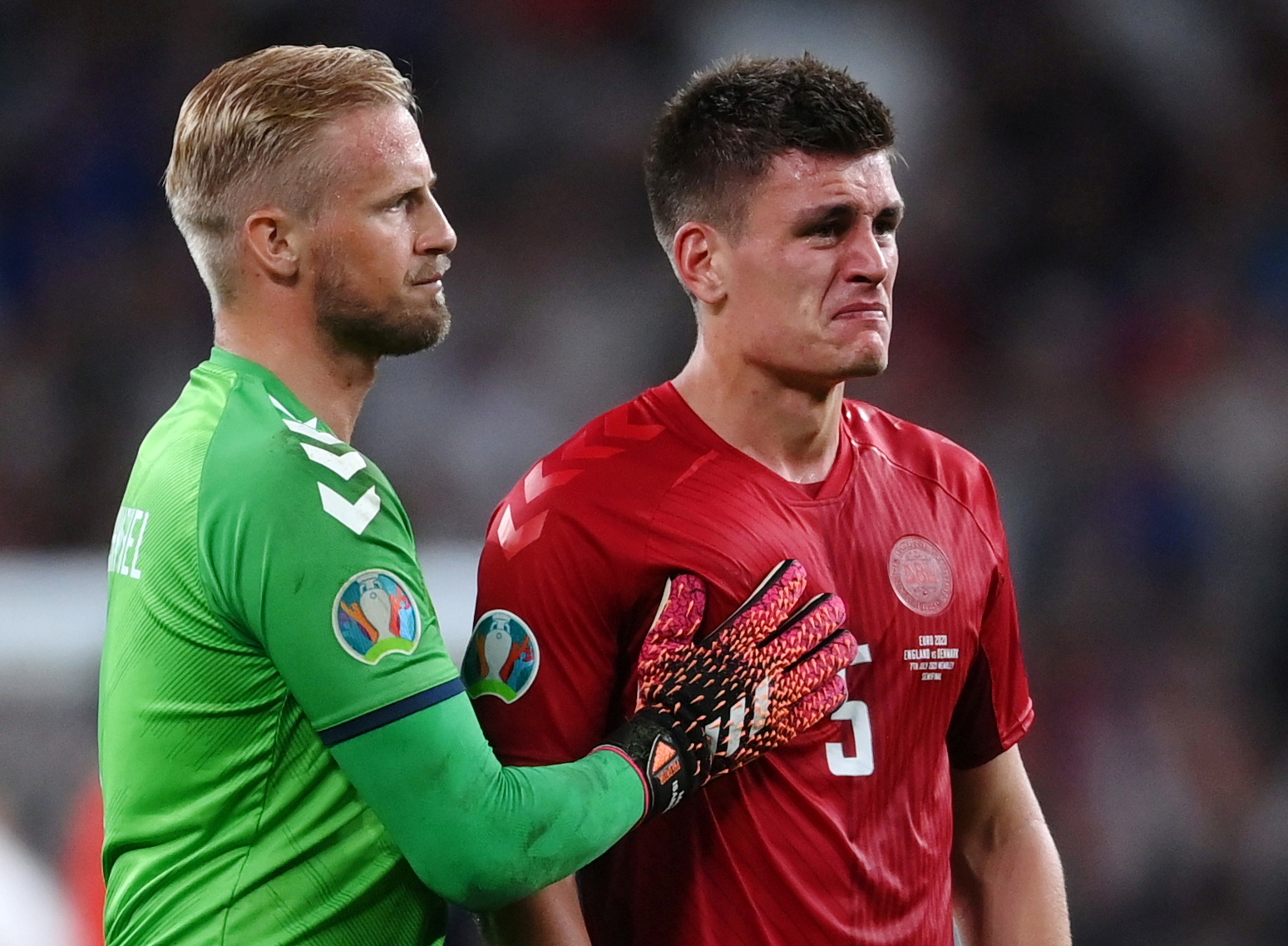 Denmark's Kasper Schmeichel, left, and Joakim Maehle look dejected after the Denmark-England match [Laurence/Pool via Reuters]