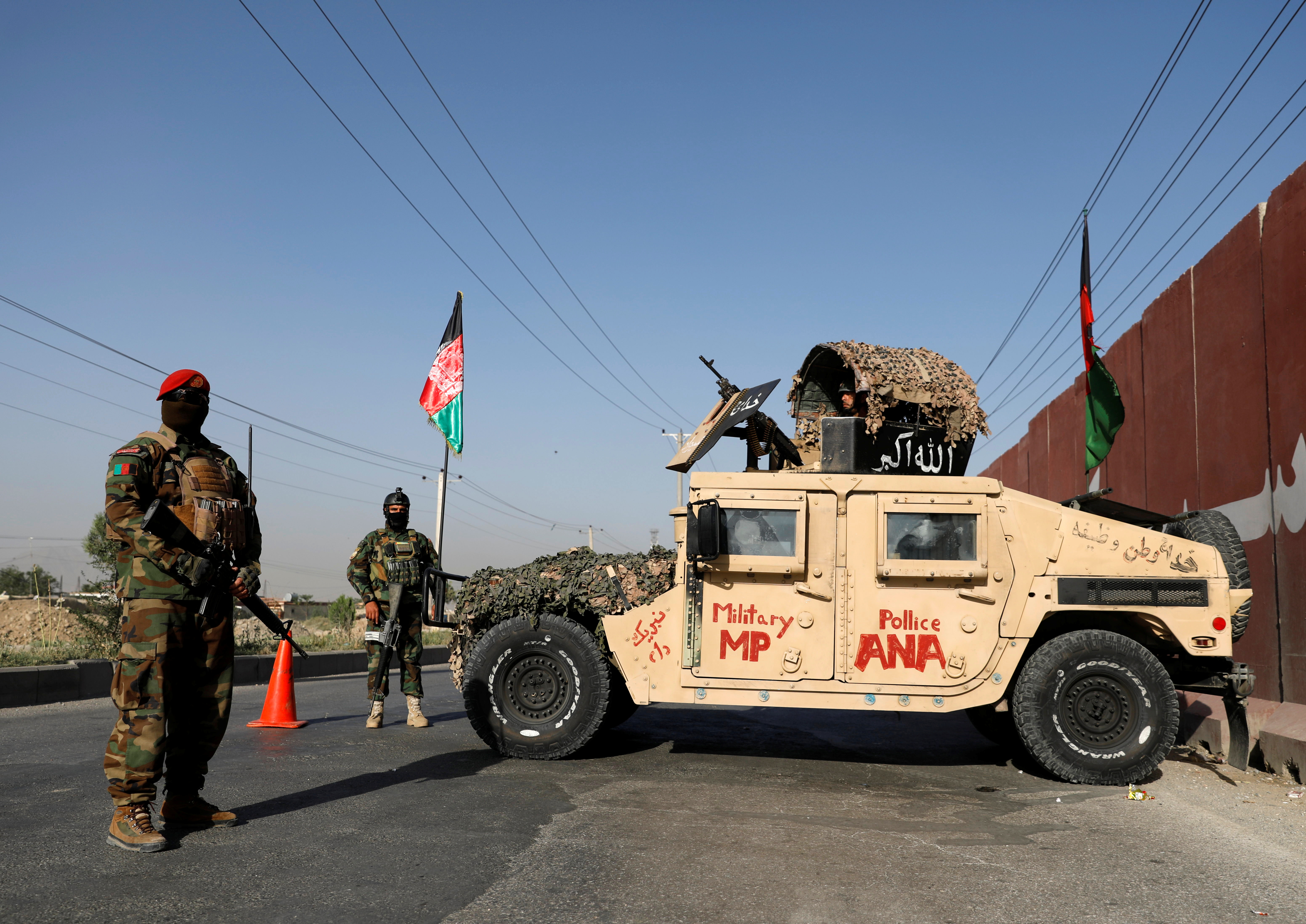 Afghan National Army officers keep watch at a check point in Kabul on July 8, 2021 [File: Reuters/Mohammad Ismail]