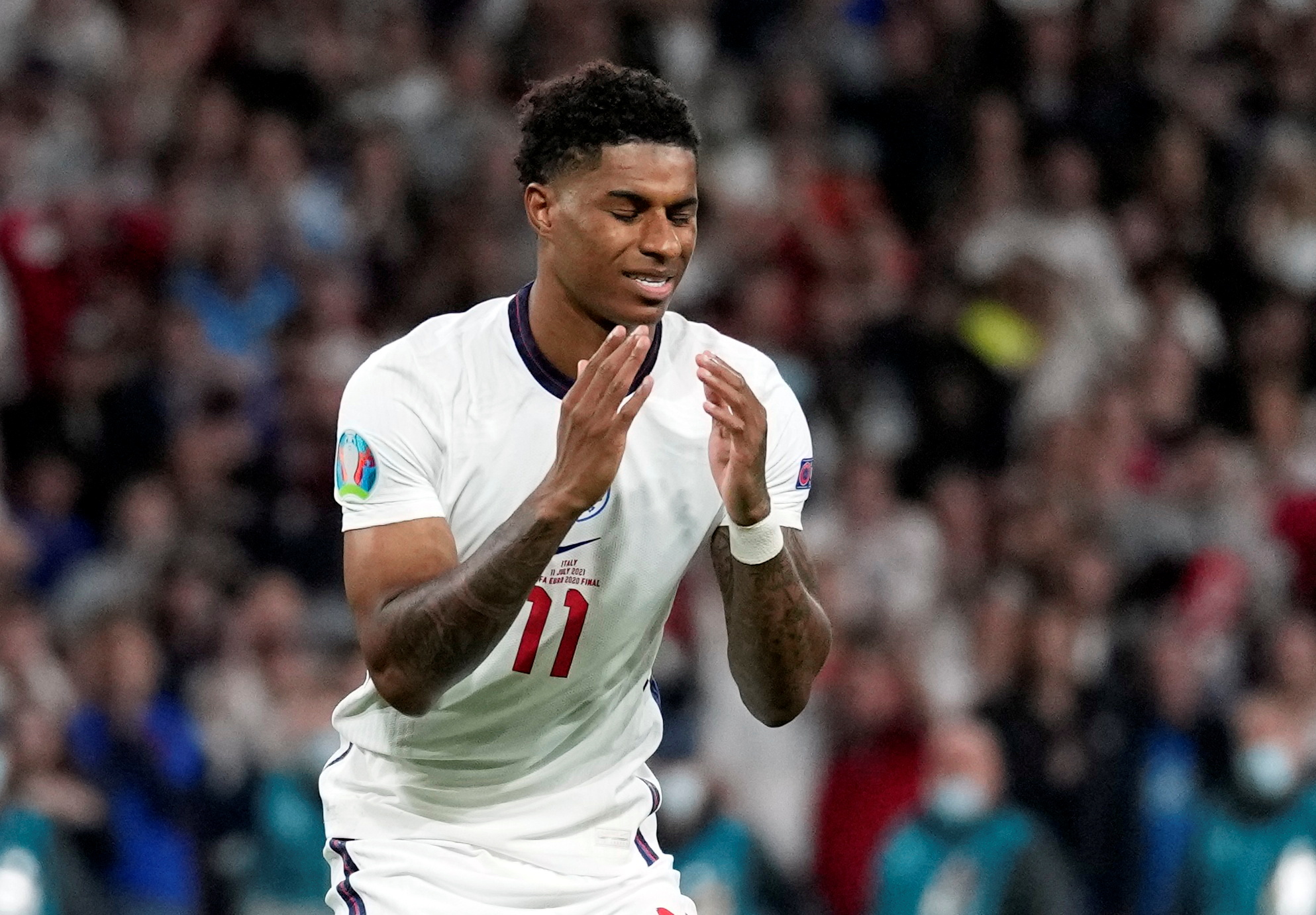 England's forward Marcus Rashford reacts after he fails to score in the penalty shoot-out [Frank Augstein/Pool/Reuters]