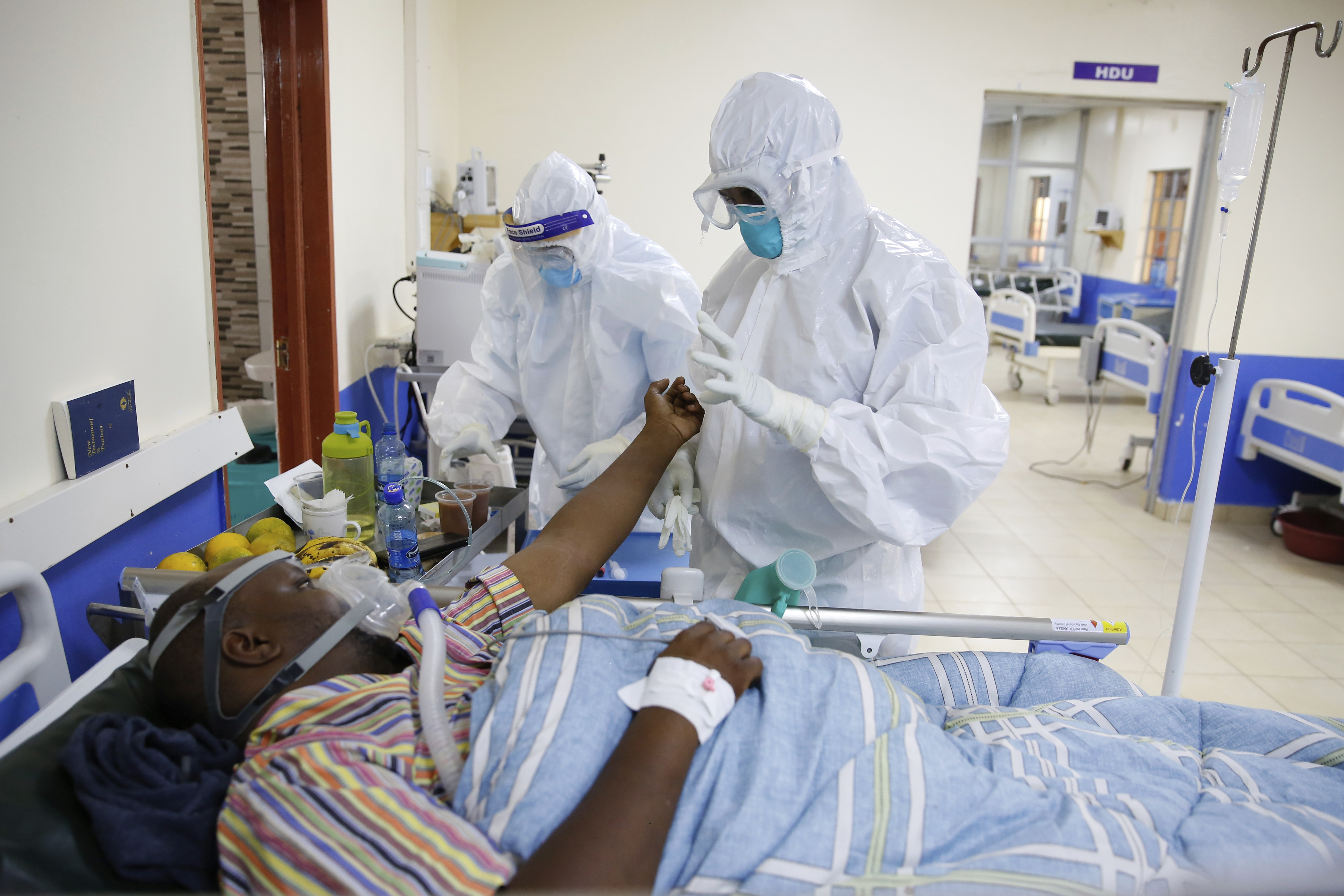 Medical staff wearing protective equipment attend to patients affected by the COVID-19, at the Intensive Care Unit of the Machakos County Level-5 hospital in Machakos, Kenya. A little more than 1 percent of the African population has been fully vaccinated against the disease, according to the WHO [File: Brian Inganga/AP Photo]