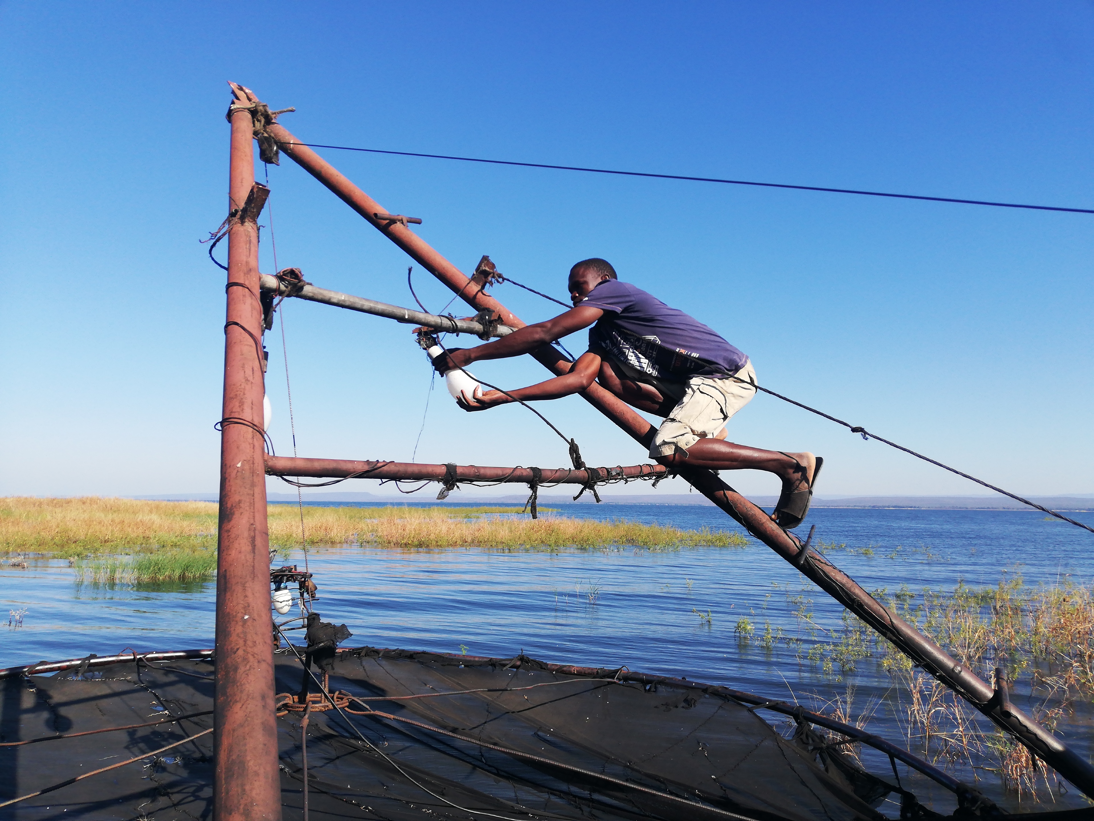 Takuchinchi Munsaka, from Muyobe village in Binga, makes final preparations before going fishing along the Zambezi River [Farai Matiashe/Al Jazeera]