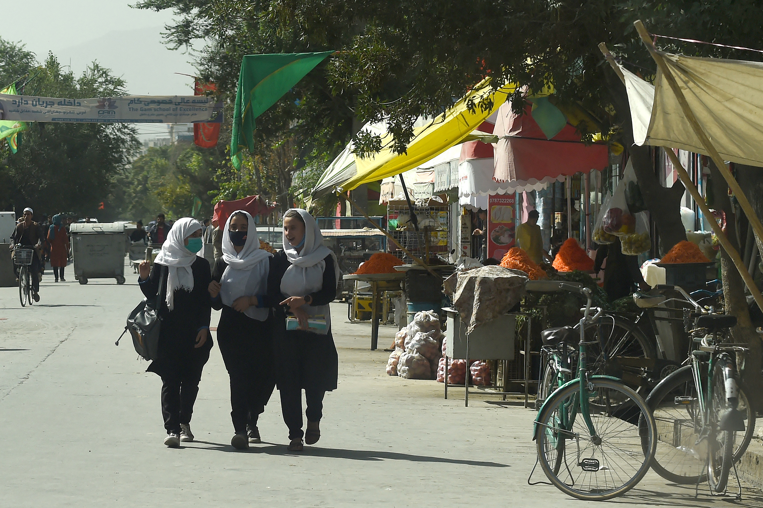 Afghan school girls walk through in a street in the capital Kabul [File: Wakil Koshar/AFP]