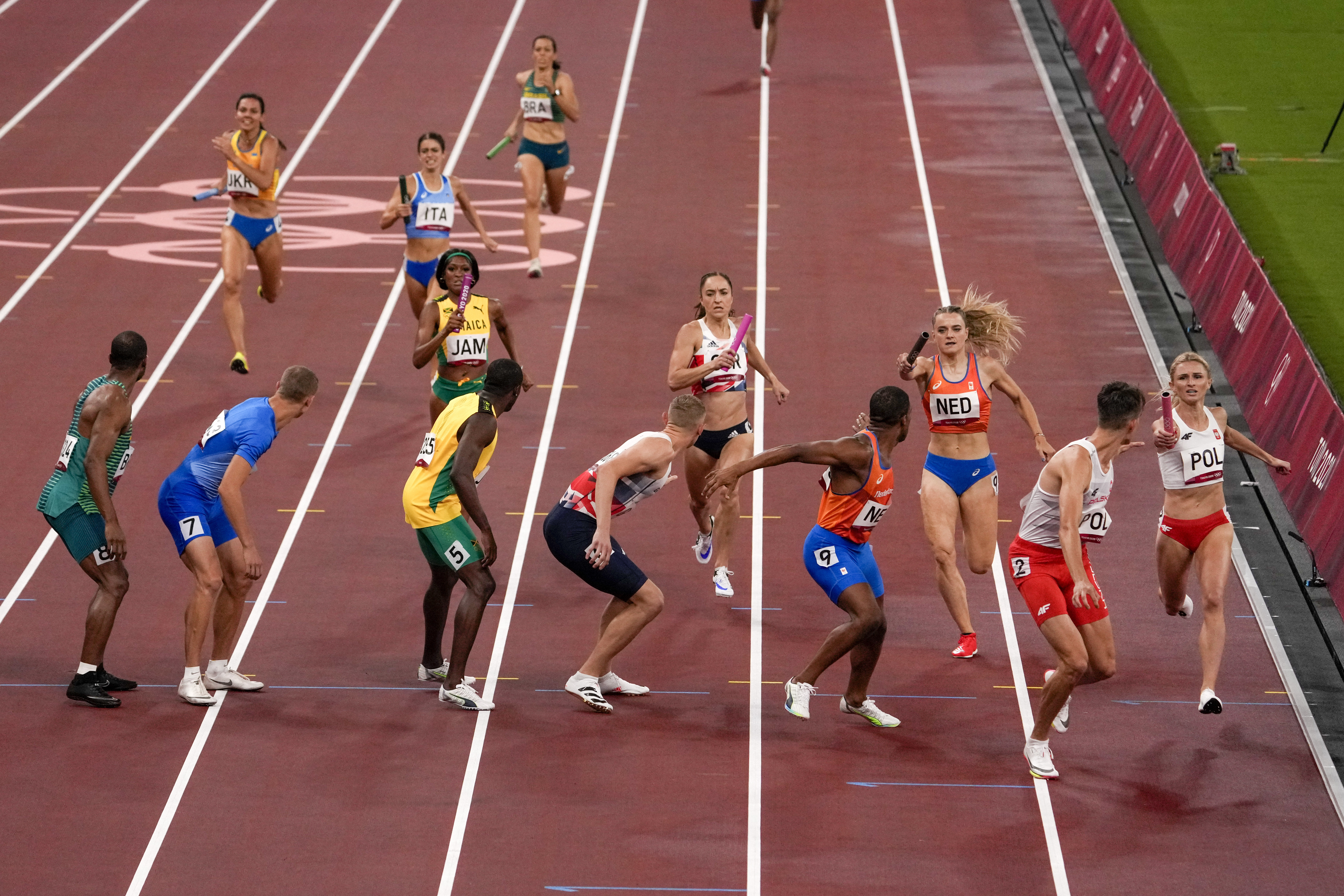 Runners compete in a heat of the 4 x 400m mixed relay at the 2020 Summer Olympics, on Friday, July 30, 2021, in Tokyo [Charlie Riedel/ AP]