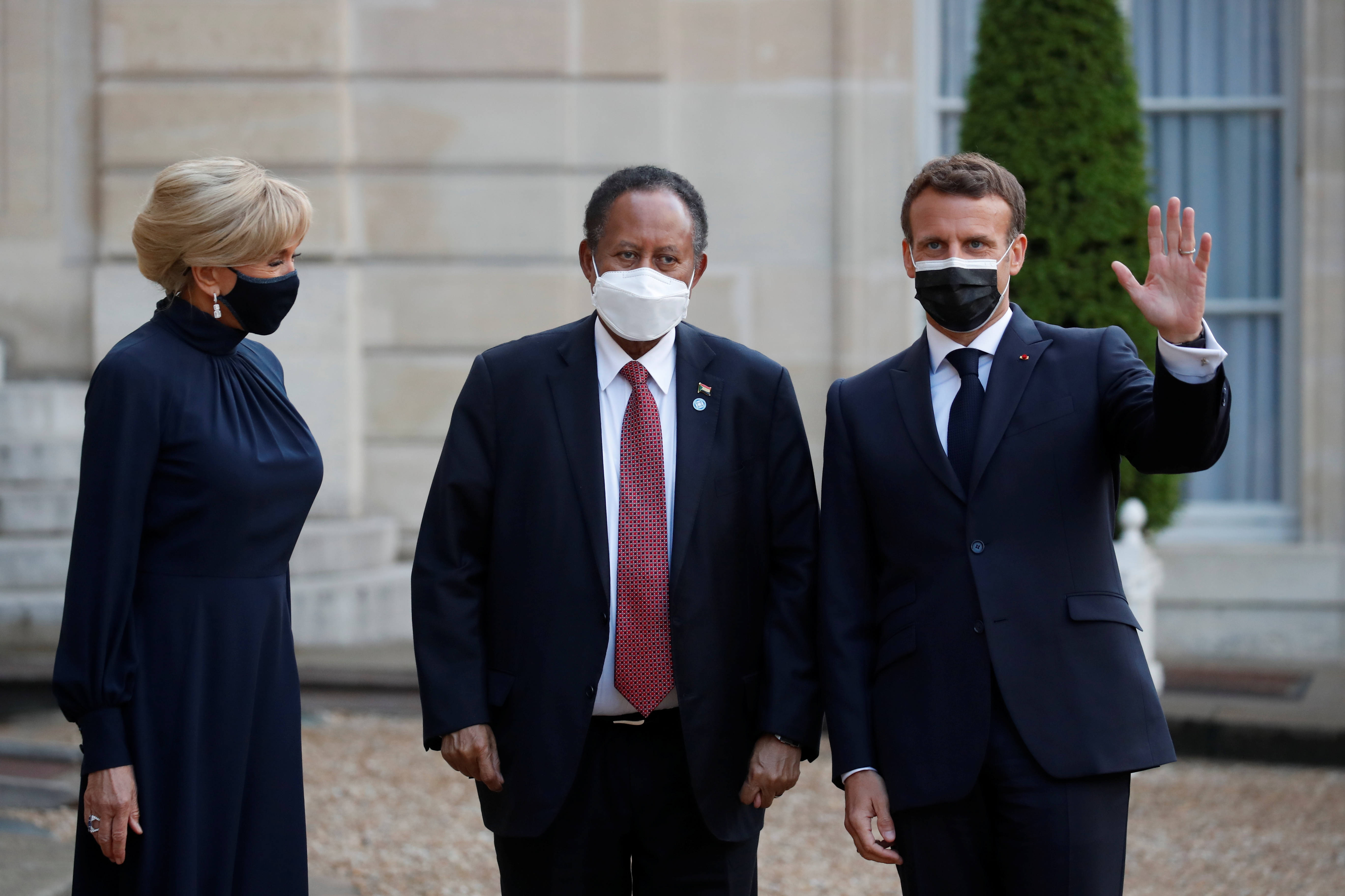 French President Emmanuel Macron and his wife Brigitte Macron welcome Sudan's Prime Minister Abdalla Hamdok for a dinner with leaders of African states and international organisations on the eve of a summit on aid for Africa, at Elysee Palace in Paris on May 17, 2021. [File: Reuters/Gonzalo Fuentes]