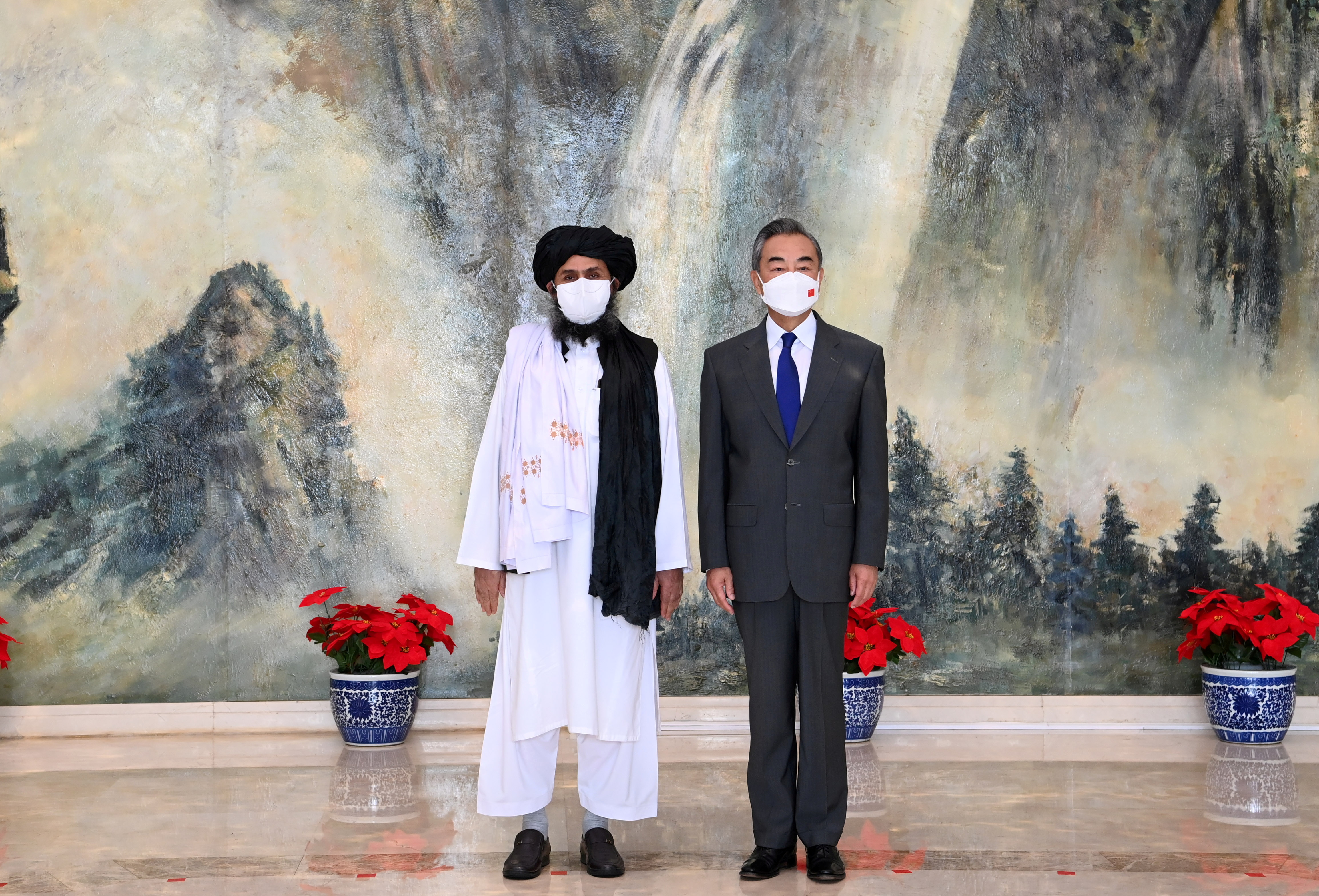 Chinese State Councilor and Foreign Minister Wang Yi meets with Mullah Abdul Ghani Baradar, political chief of Afghanistan's Taliban, in Tianjin, China on July 28, 2021 [File: Li Ran/Xinhua via Reuters]