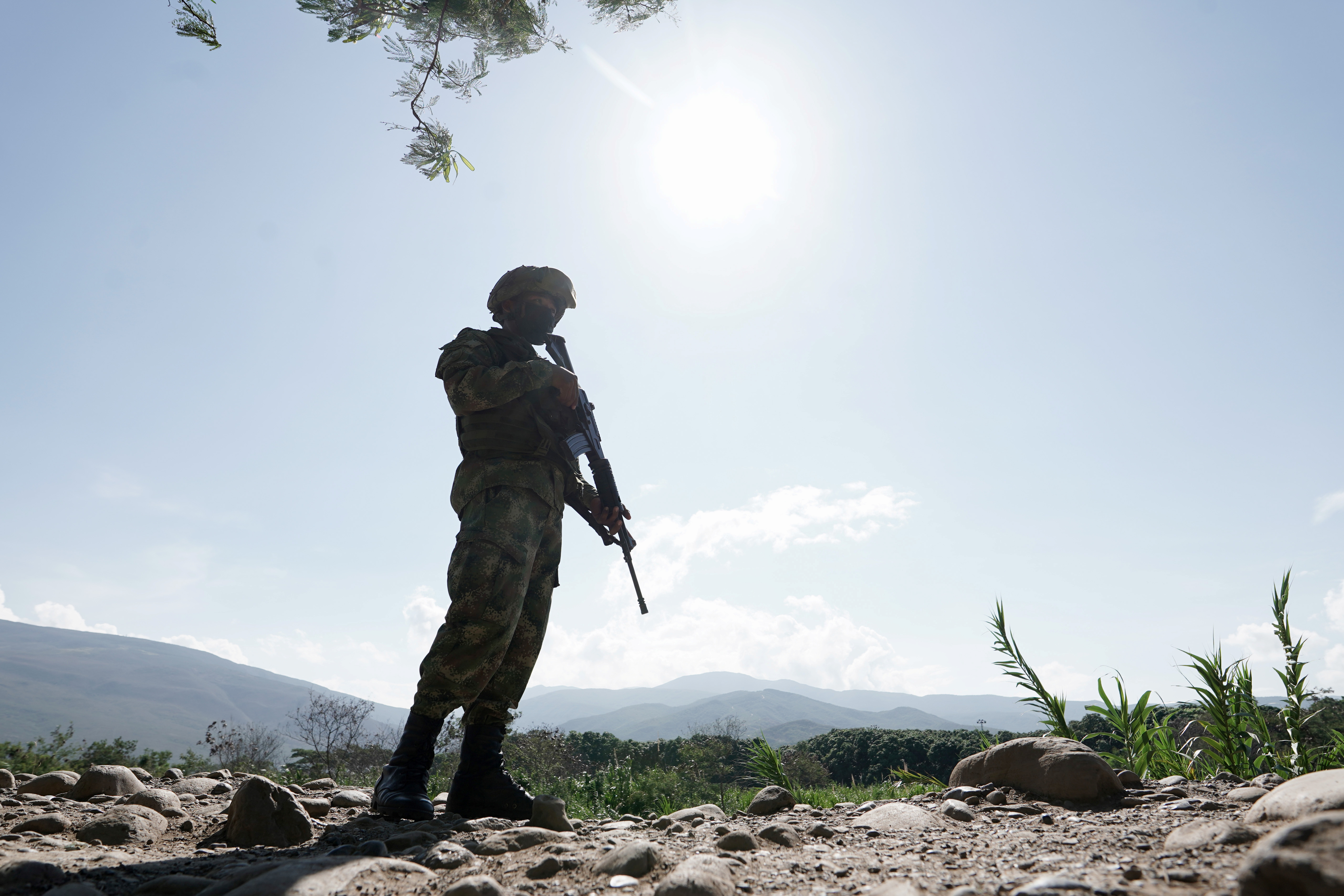 A member of the Colombian military patrols an unofficial crossing between Colombia and Venezuela, as the two countries are gradually reopening their shared border [Nathalia Angarita/Reuters]