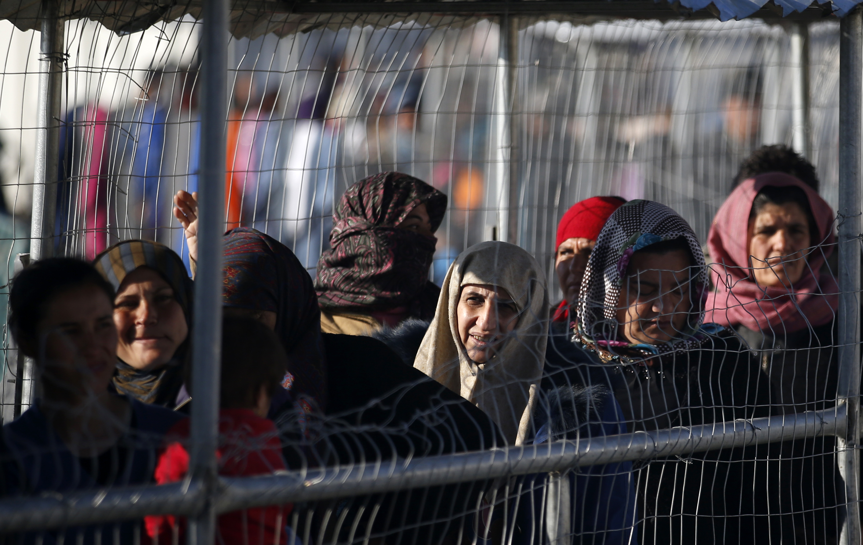 Migrants wait for food in the makeshift refugee camp at the northern Greek border point of Idomeni, Greece,