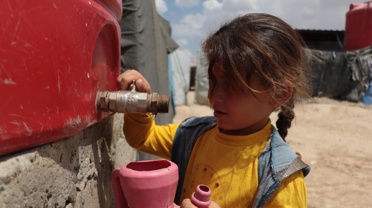A Syrian girl fetches water from a tank in the al-Hol displacement camp in northeast Syria [Courtesy: Save the Children]