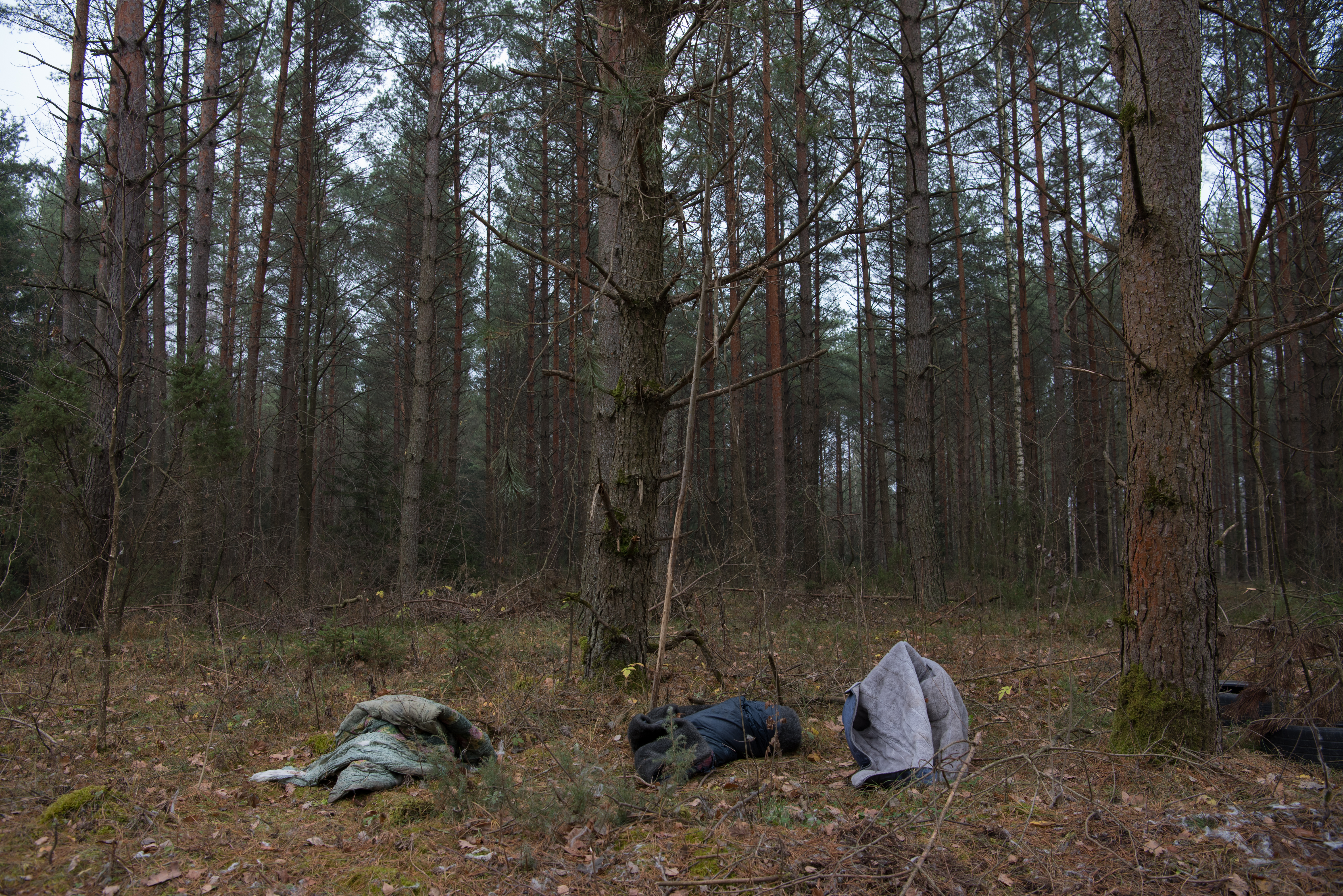 Three jackets left behind in the woods. It is not clear what happened to their owners. All over the woods around the border area are traces of people who tried to cross them. [Vincent Haiges/Al Jazeera]