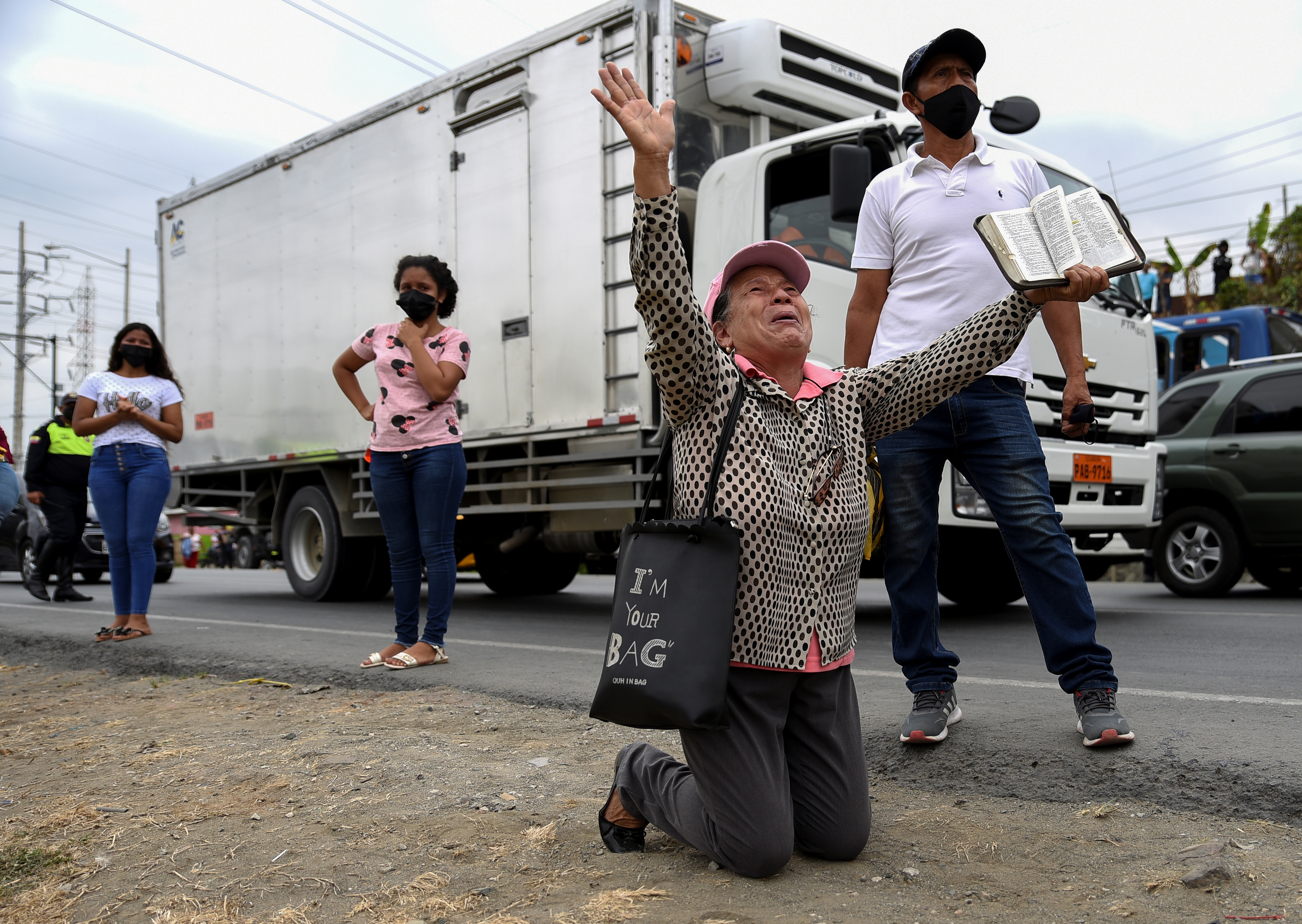 Family members of people held in Ecuador's prisons pray for the safety of their loved-ones after a series of deadly riots [File: Vicente Gaibor del Pino/Reuters]