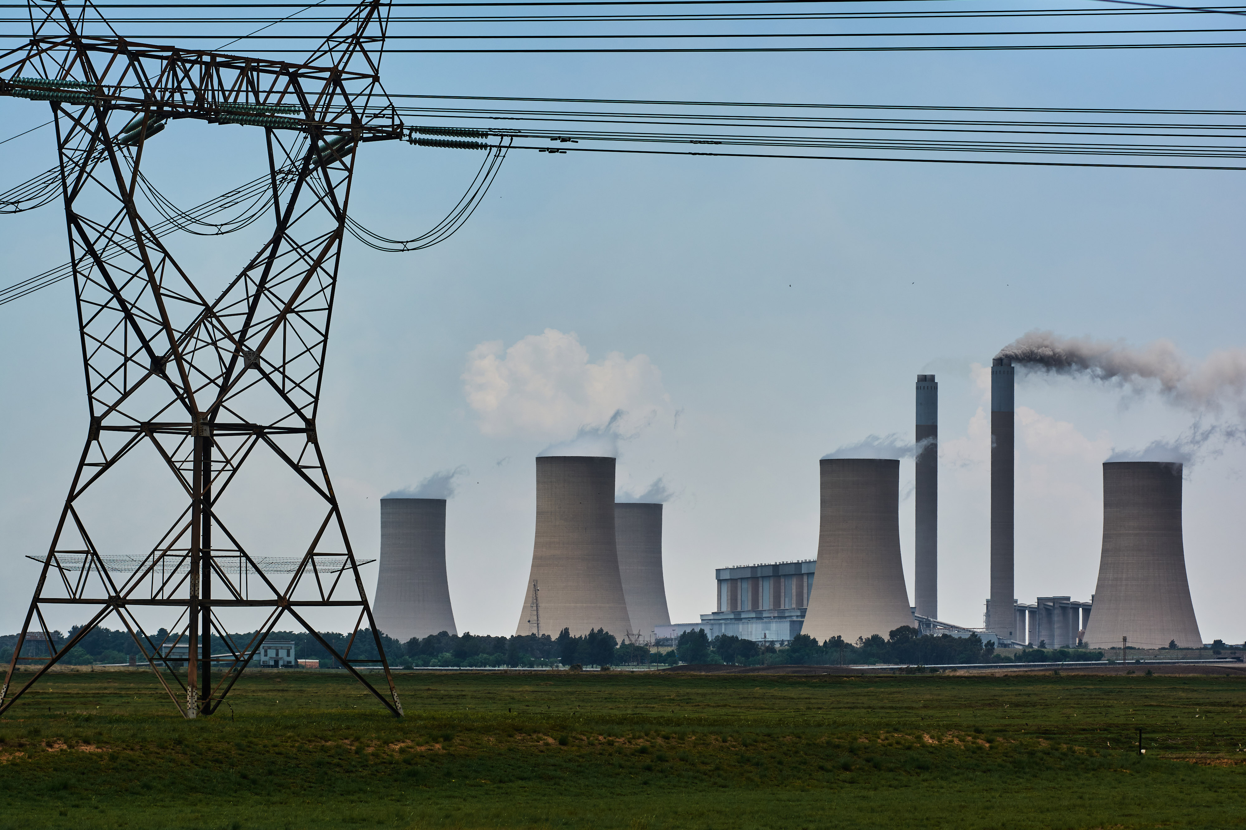 An electricity transmission tower close to the Eskom Holdings SOC Ltd. Lethabo coal-fired power station in Vereeniging, South Africa
