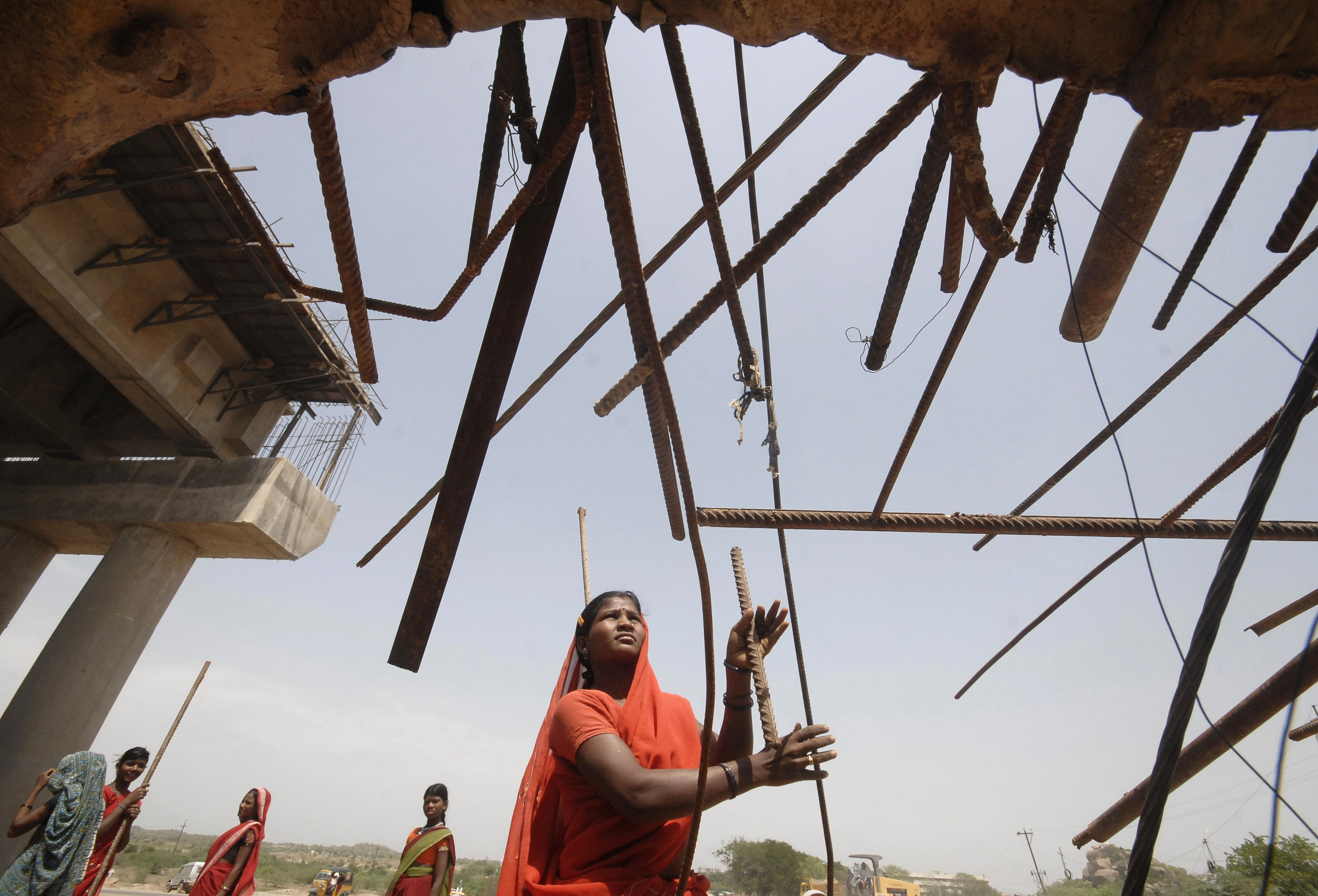 A woman labourer works at a road construction site outside Hyderabad city in India
