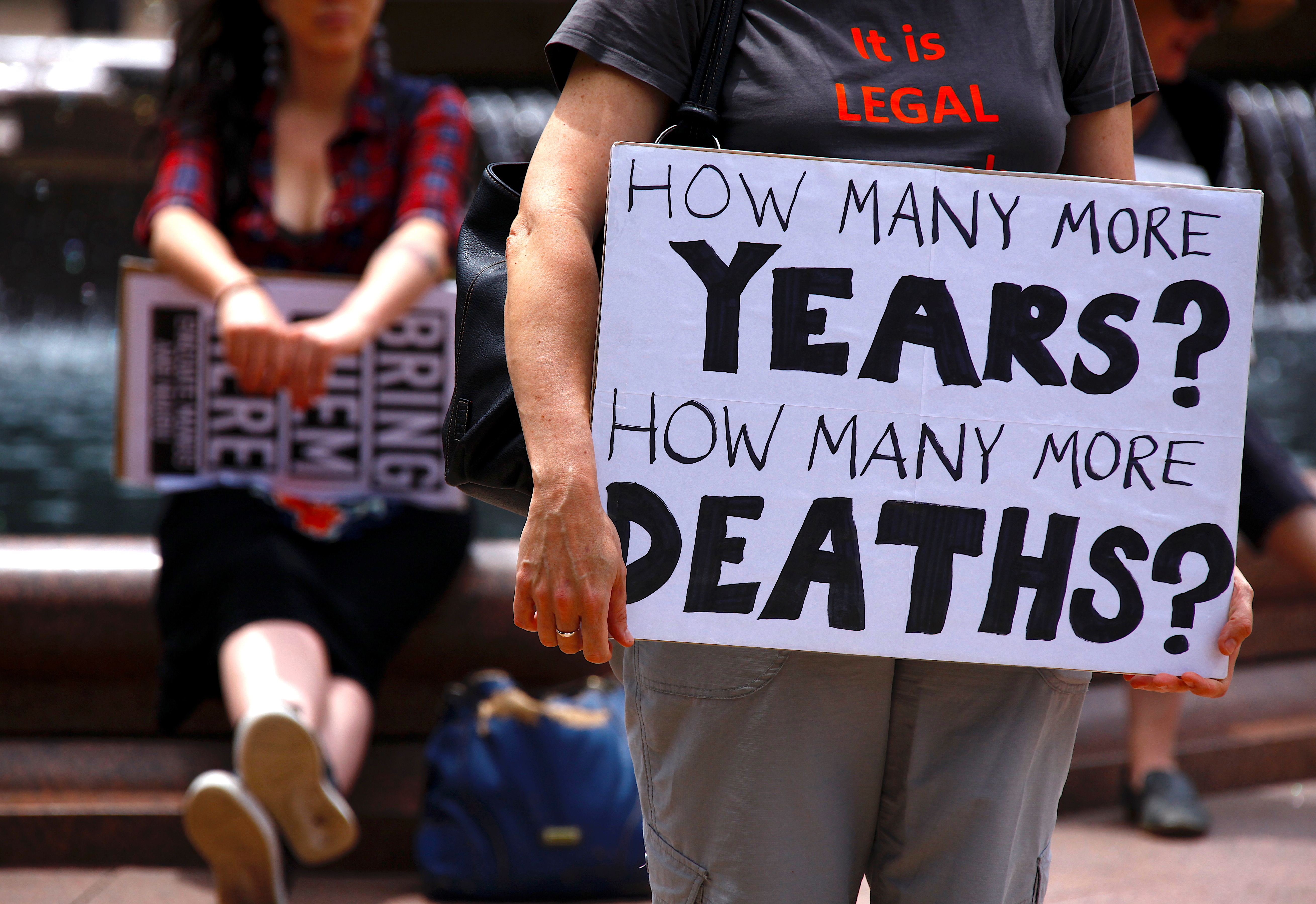 Refugee advocates hold placards as they participate in a protest in Sydney, Australia, against the treatment of asylum seekers at Australia-run detention centres located at Nauru and Manus Islands, November 18, 2017 [File: David Gray/ Reuters]