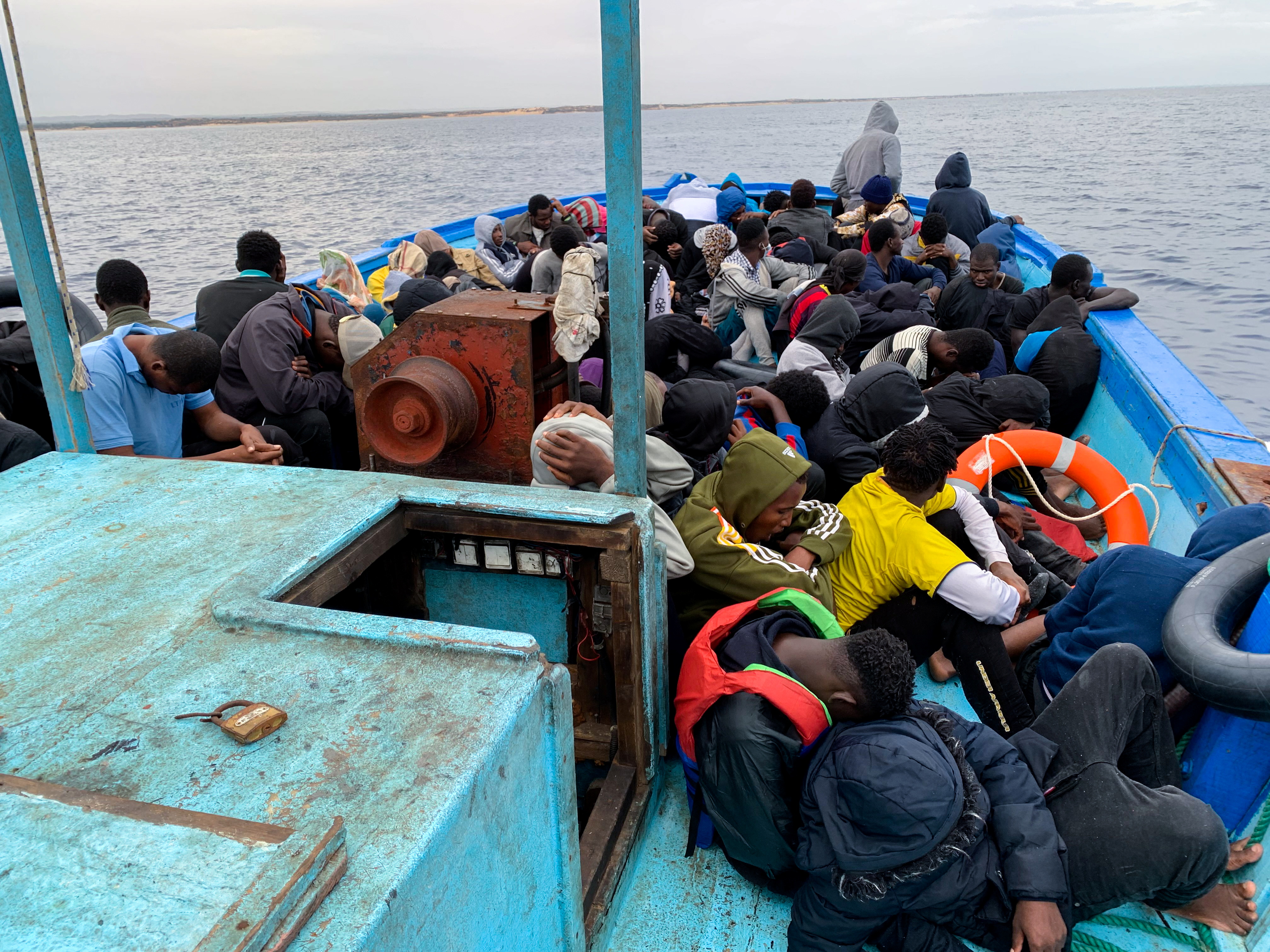 Migrants are seen in a boat as they were picked up by Libyan Coast Guards in the Mediterranean Sea, off the coast of Libya on October 18, 2021 [File: Reuters/Ayman Al-Sahili]