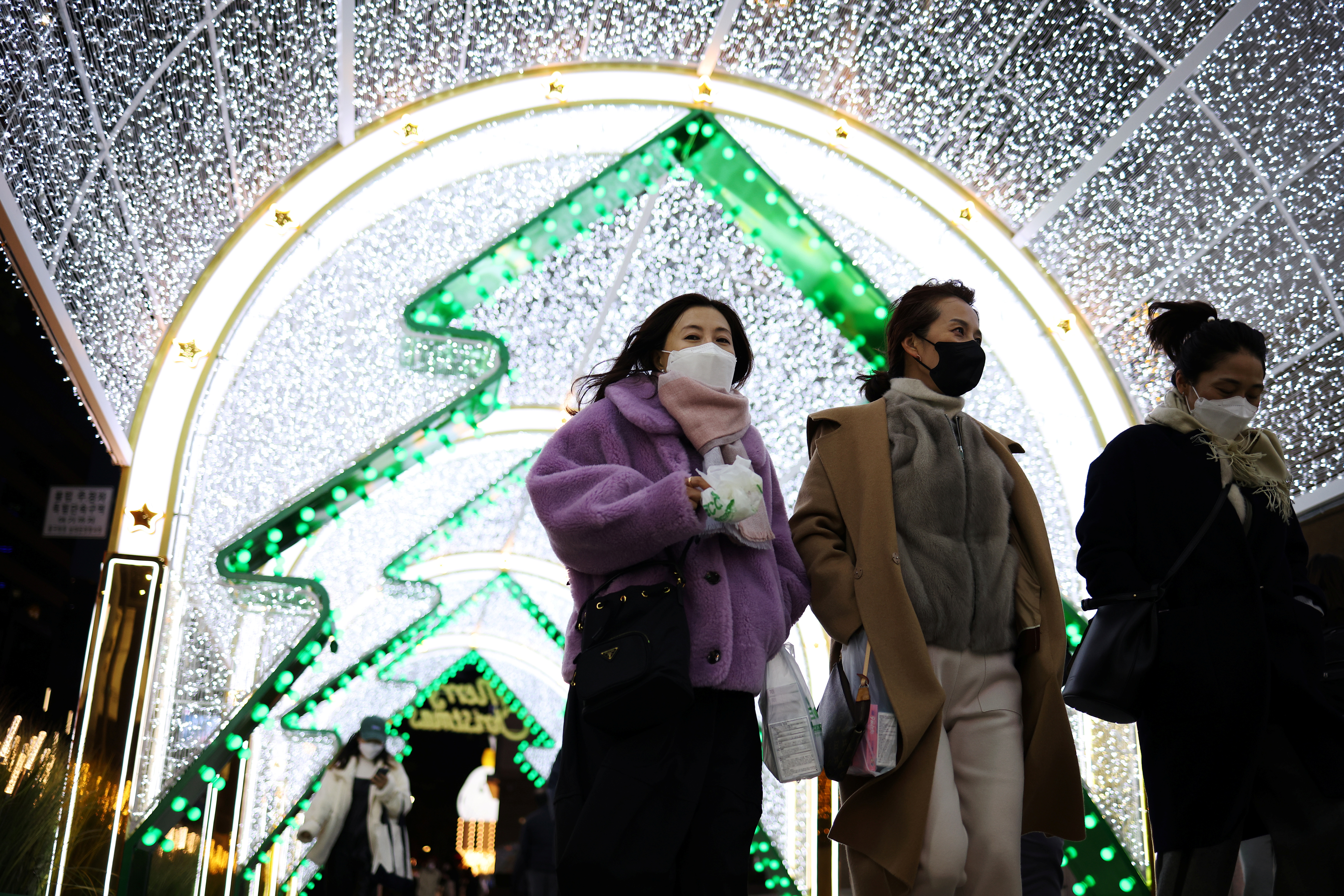 South Korean women walking in Seoul, South Korea, during COVID.