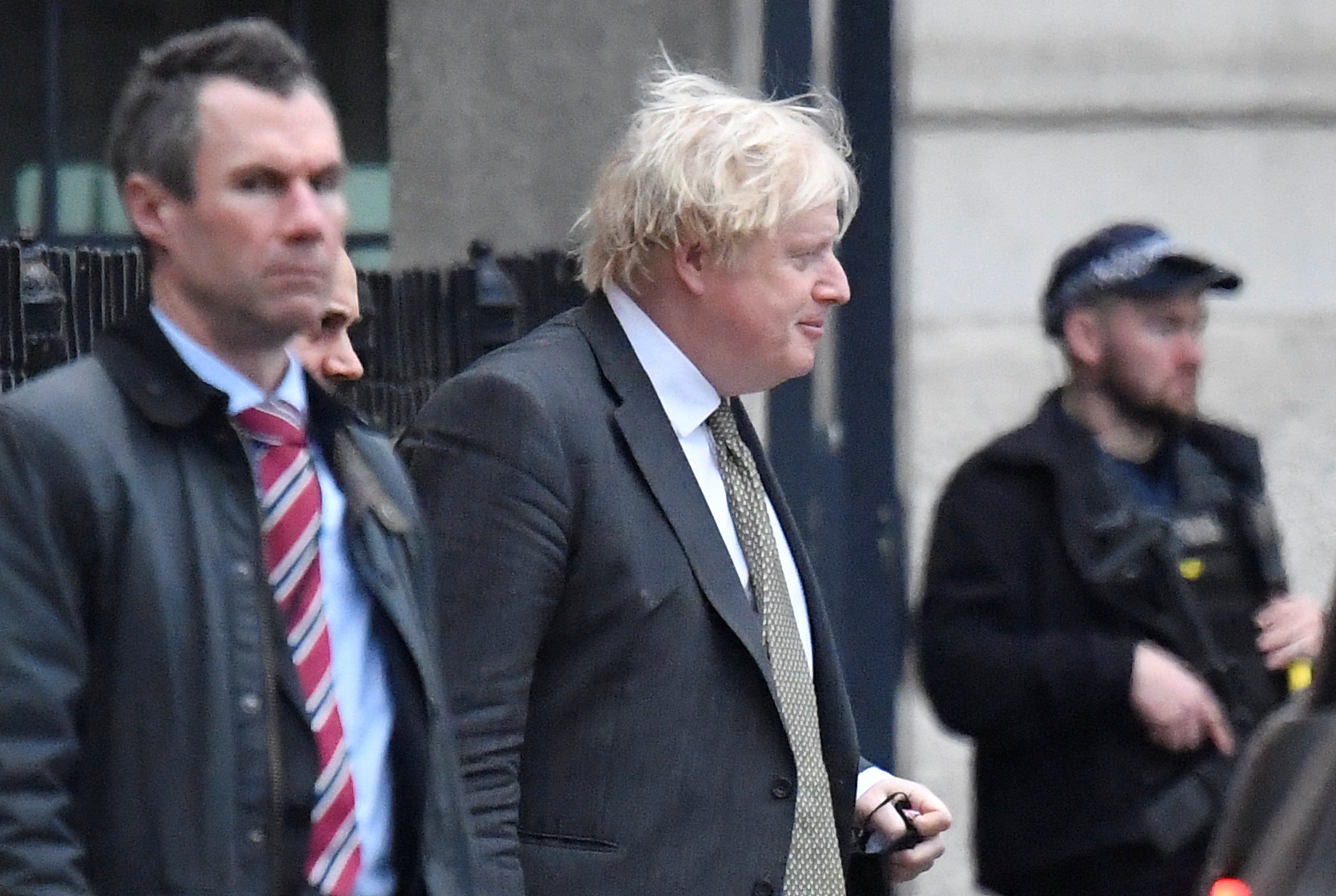 British Prime Minister Boris Johnson walks out of a back entrance to Downing Street, in London, UK, December 17, 2021 [Toby Melville/Reuters]