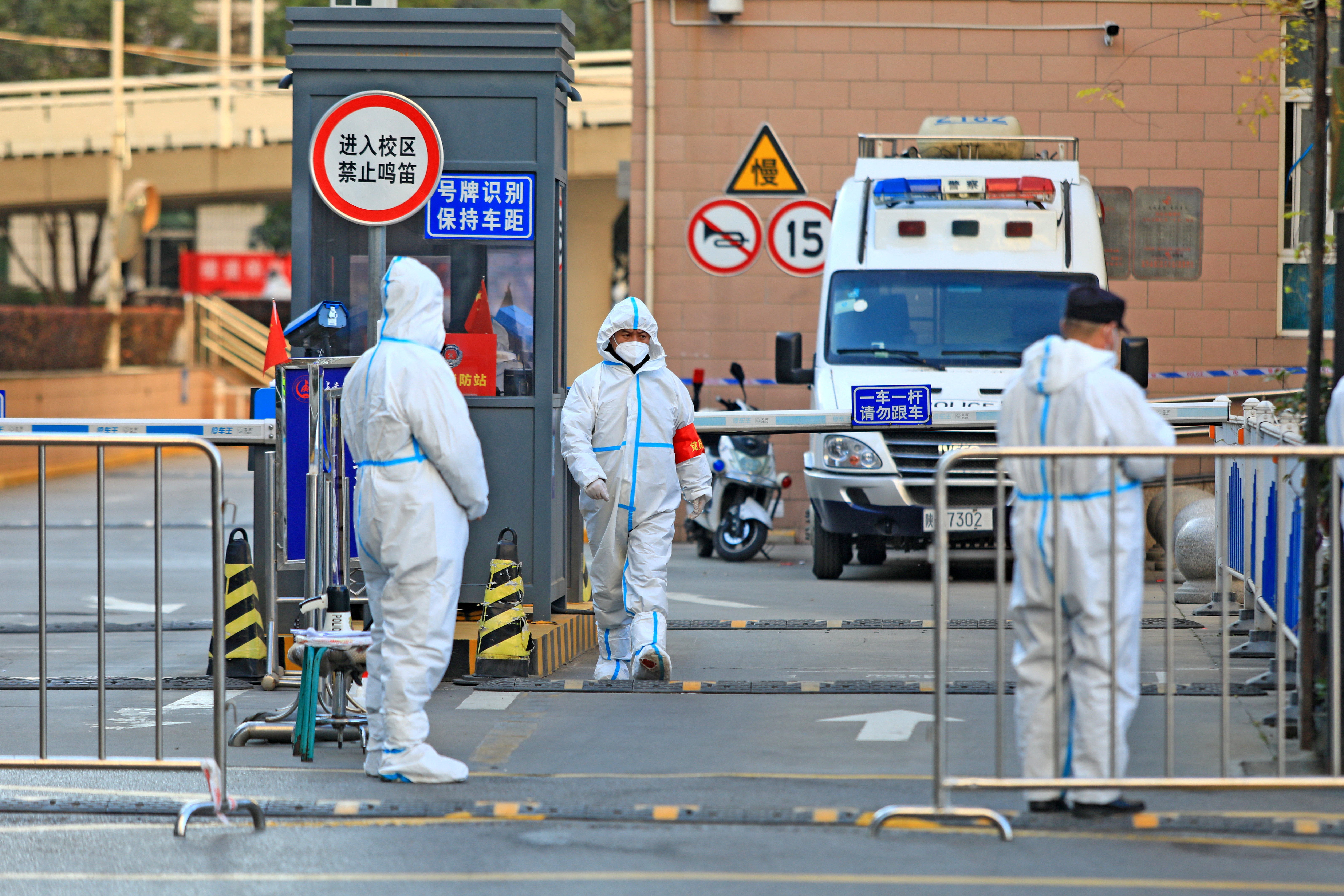 Health officials in hazmat suits in Xian, China
