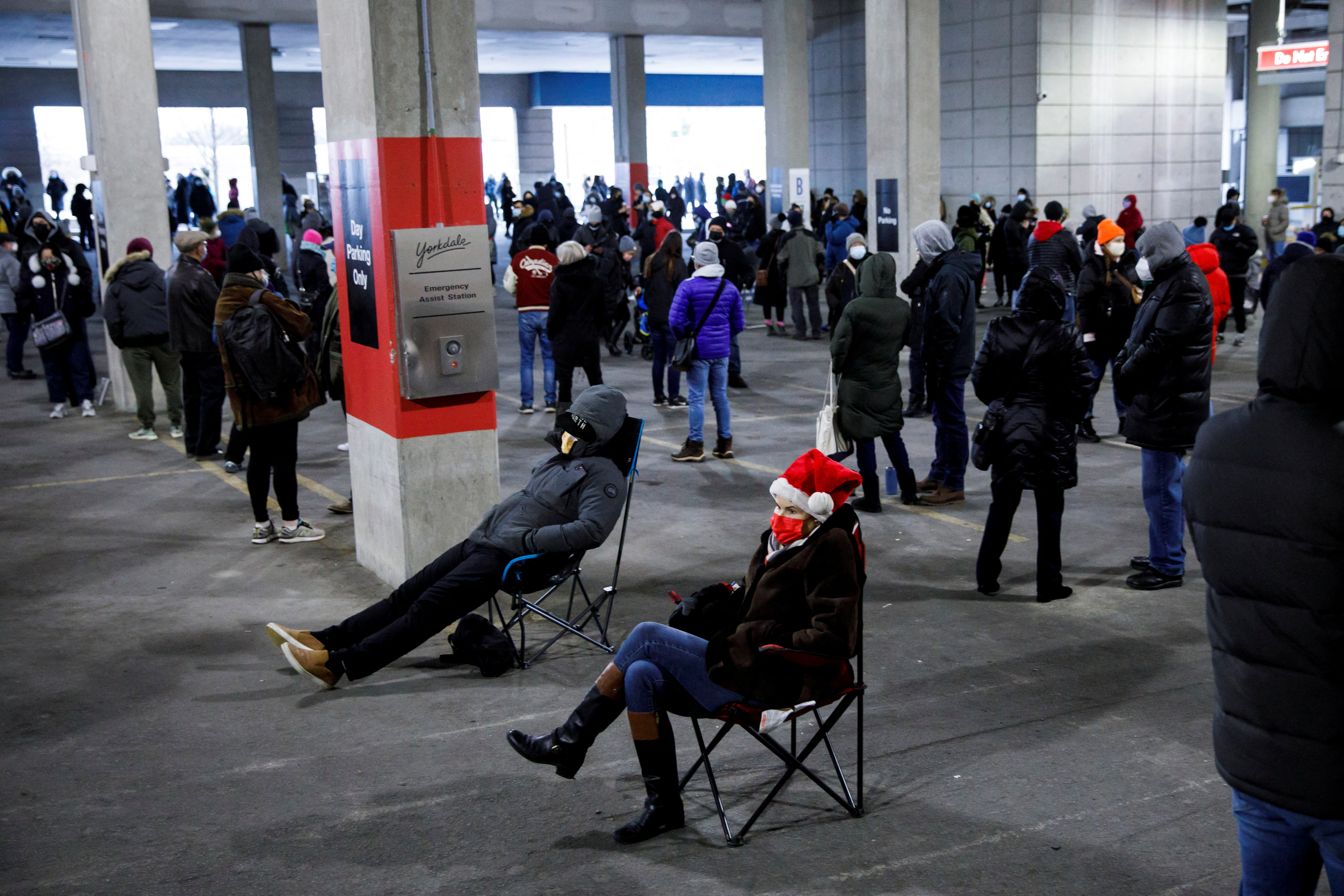 People queue to pick up coronavirus antigen test kits in Toronto in December