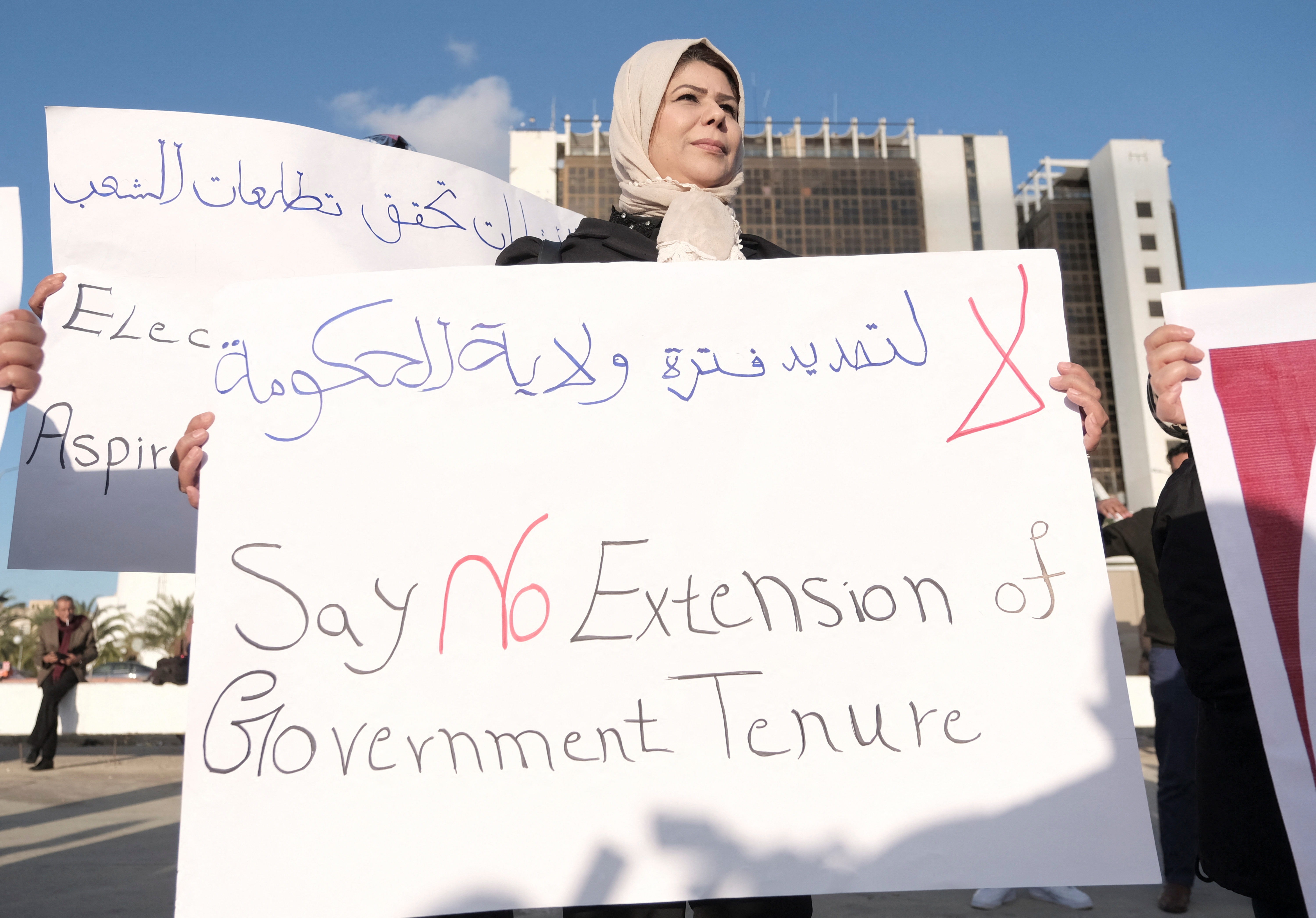 A woman holds a banner during a protest