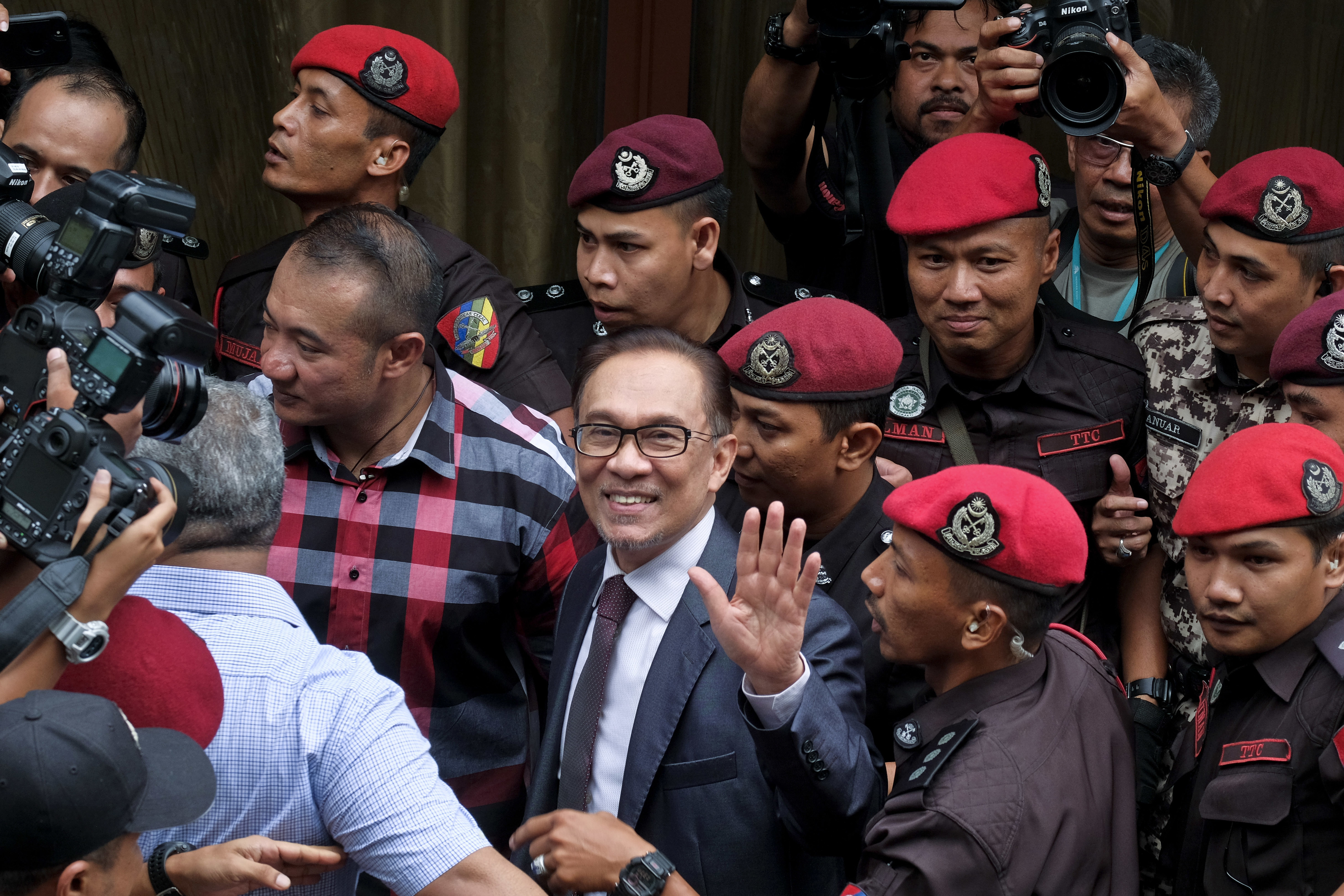 Malaysia's reformist icon Anwar Ibrahim arrives at his house in Kuala Lumpur, Malaysia, Wednesday, May 16, 2018. Malaysia's reformist icon Anwar Ibrahim has been freed from custody after receiving a royal pardon, paving the way for a political comeback following his alliance's stunning election victory. (AP Photo/Sadiq Asyraf)