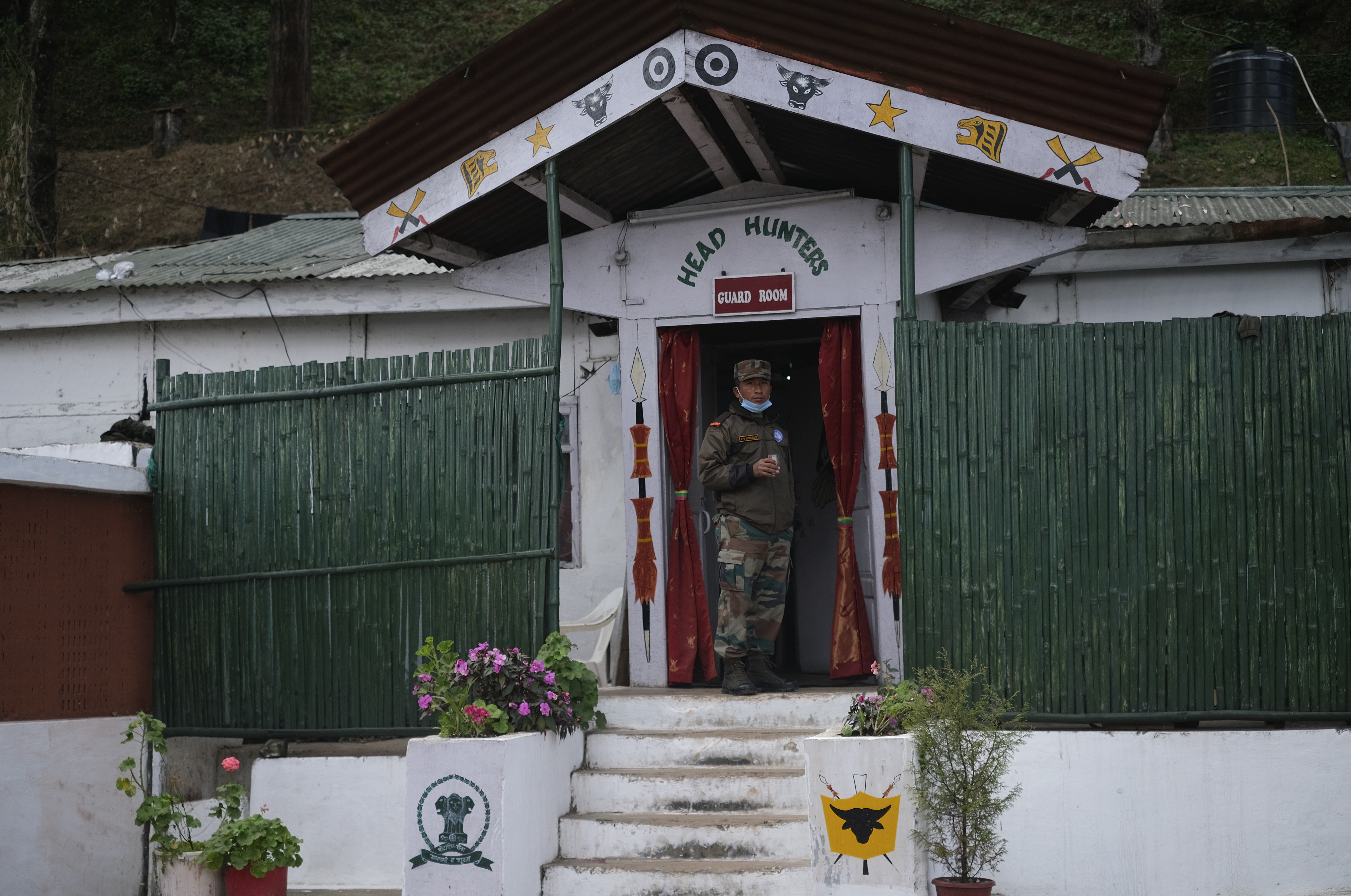 An Indian army soldier stands outside a guard room at an army camp in Jakhama, outskirts of Kohima, northeastern Nagaland state, India, Sunday, December 5, 2021